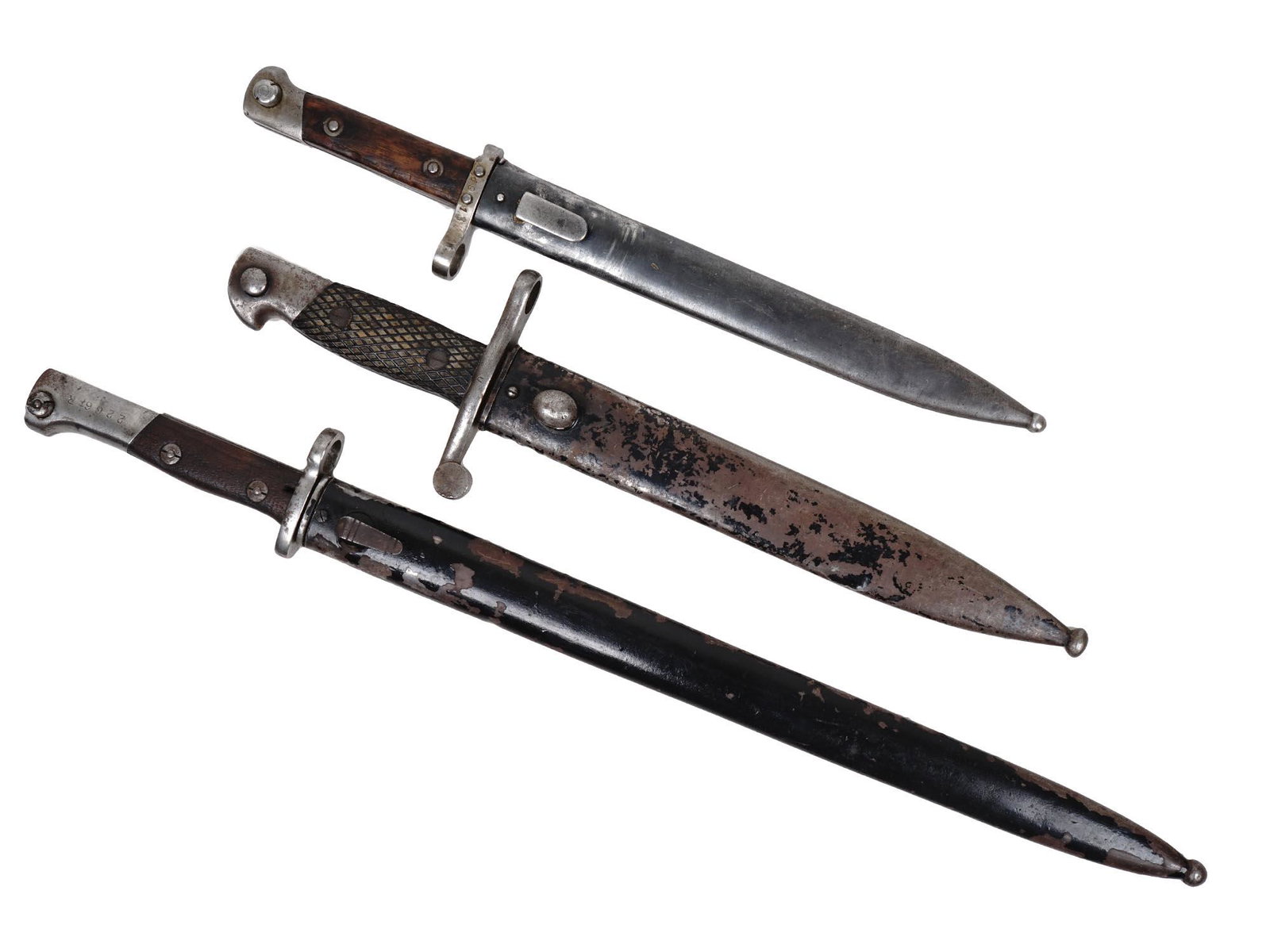 A LOT OF THREE WWII BAYONETS.: 1st- Austrian bayonet WW I - WWII for 1895 Mannlicher M95 OEWG. 2nd-Spanish Model 1941 Mauser Rifle Bayonet Toledo Arsenal. 3rd-German Mauser K98 long bayonet for export. Dimensions: Largest Item L 21