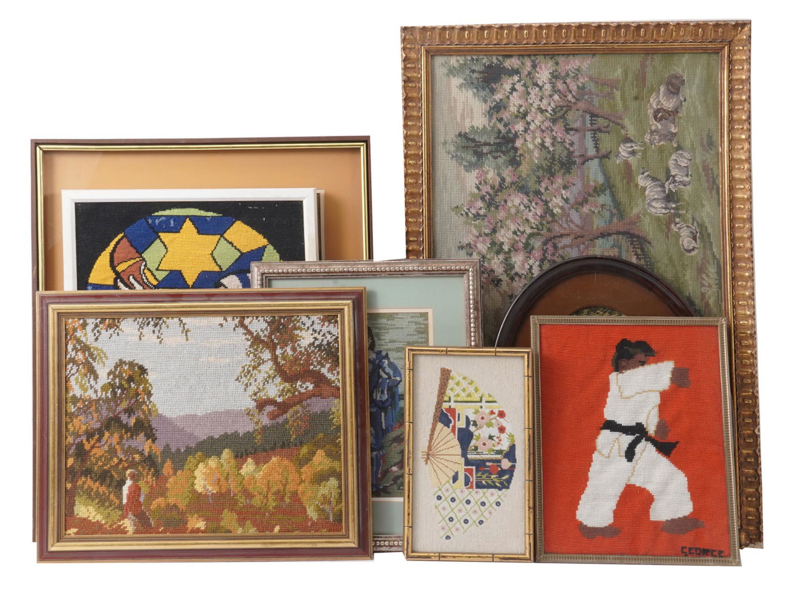 FRAMED EMBROIDERED PAINTINGS LANDSCAPES JUDAICA: A set of seven framed embroidered paintings. A karate athlete, signed George in the lower right. An ornamented oriental fan. An autumn landscape. A copy of a XVII-century Dutch interior painting by Pi