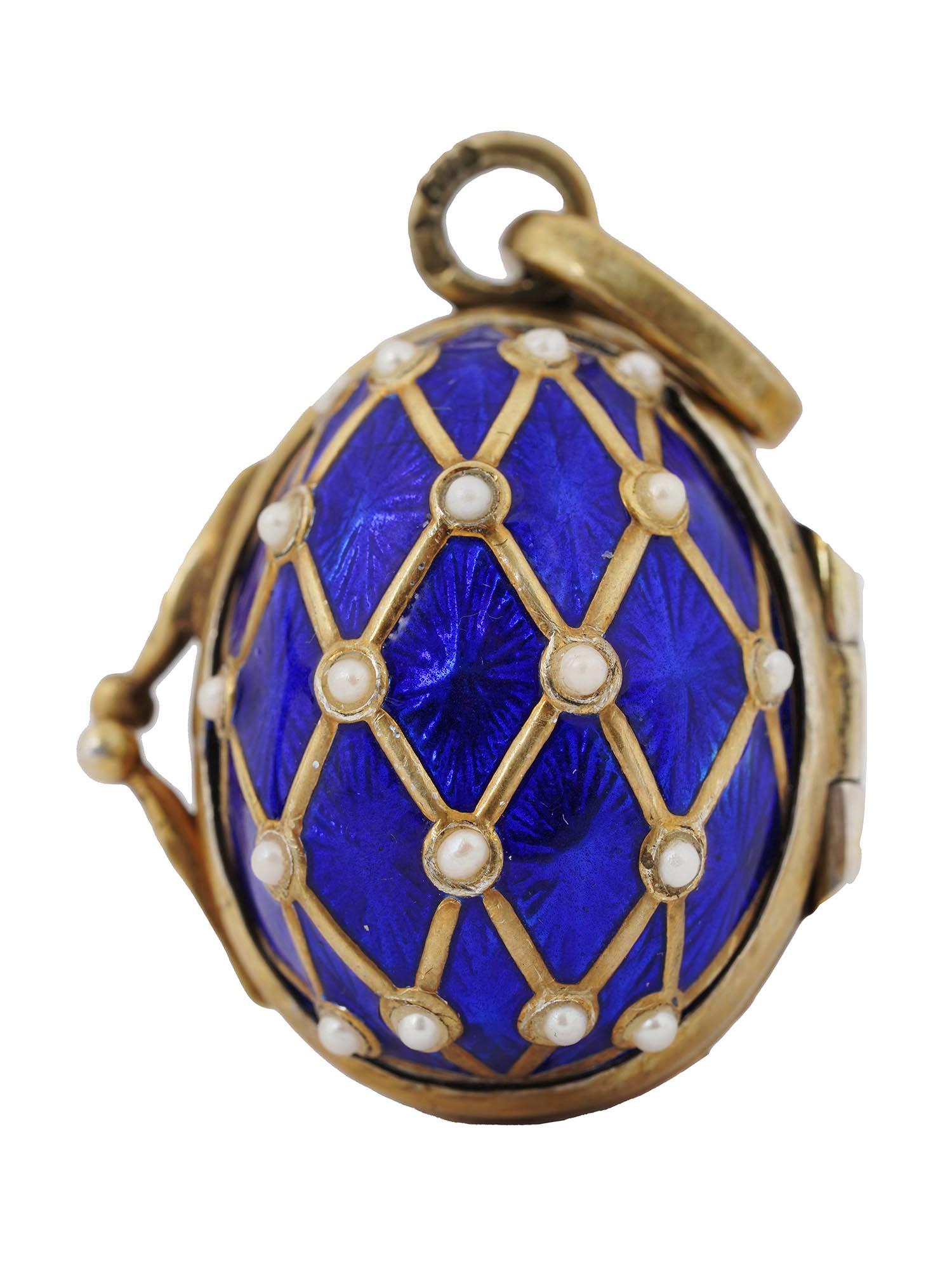 RUSSIAN SILVER GILT, ENAMEL, PEARLS EGG LOCKET: A very nice Russian silver gilt egg locket covered with bright blue shimmering guilloche enamel and decorated with intersecting gold stripes and hemispherical pearls at the crosshairs. Opens to reveal