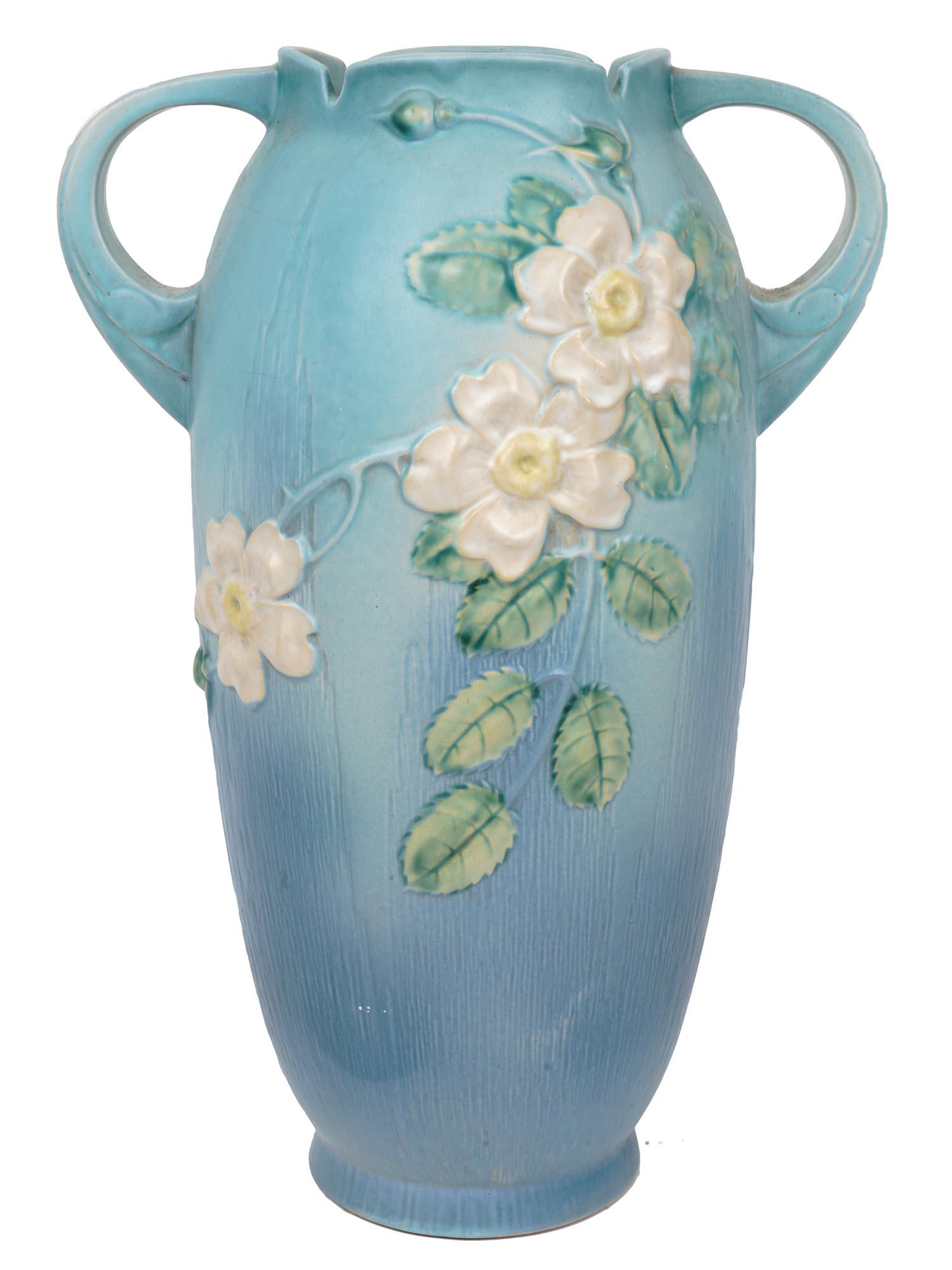 LARGE ROSEVILLE BLUE APPLE BLOSSOM POTTERY VASE: A large Roseville amphora shaped blue pottery vase with a pair of handles. The exterior of the vase is adorned with a hand crafted Apple Blossom design. Marked with an impressed factory stamp and numb
