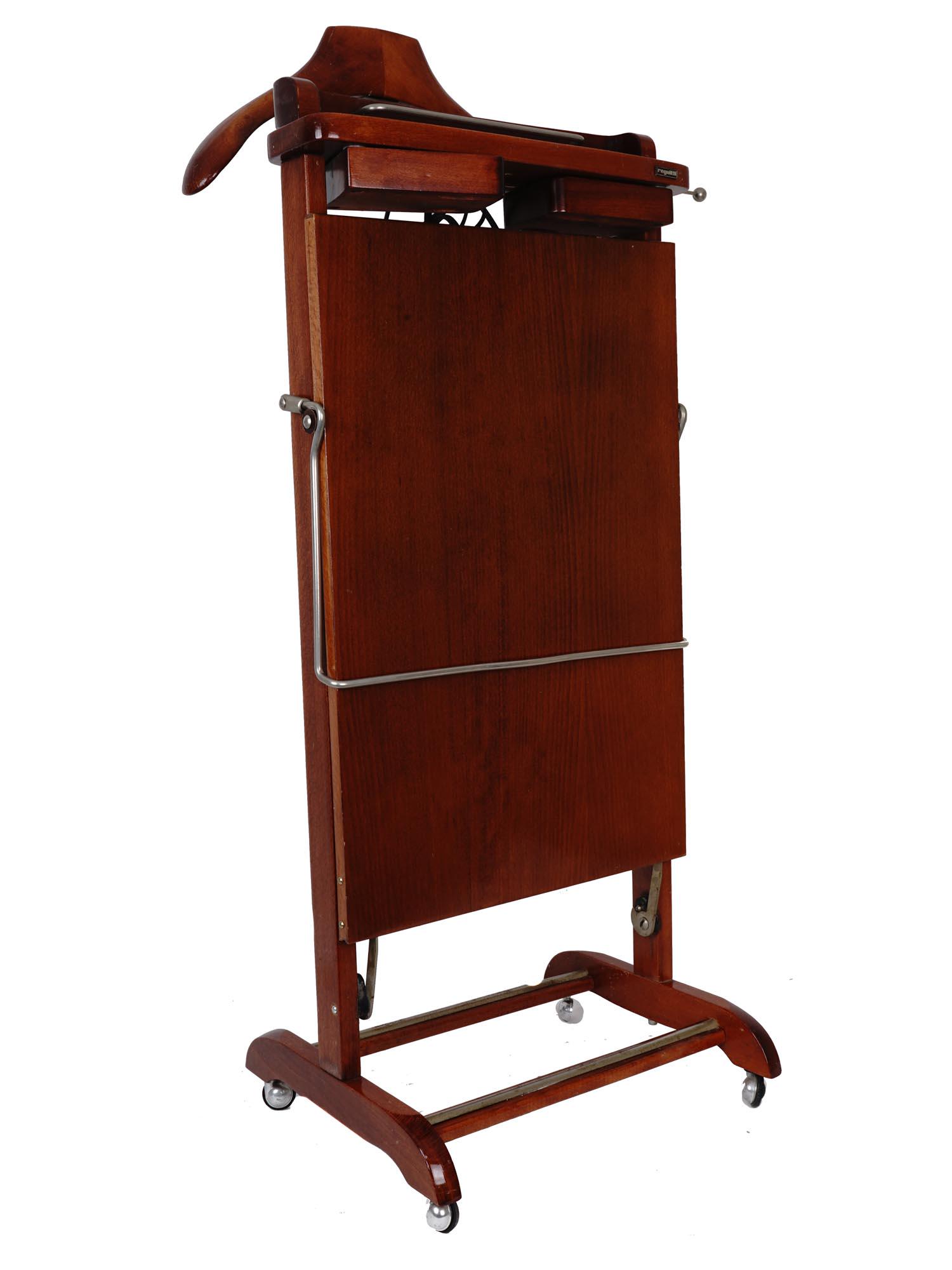 FRATELLI REGUITTI VALET STAND WITH PANTS PRESS: Notes, mid-century, Italy. has plug-in pants press. swing out cuff links holders Dimensions: Size: H 42 3/4 x H 18 3/4 x L 10 in. All measurements are approximate.