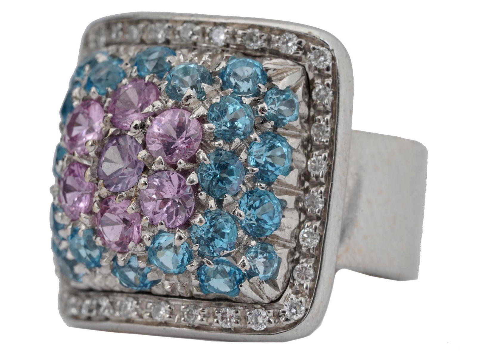 18K GOLD MULTI COLOR SAPPHIRE RING WITH DIAMONDS: An 18K white gold statement ring with a thick band and a square centerpiece. The ring is set with blue and pink sapphire gemstones surrounded by a rim of diamonds. Size 7. Hallmark with 18K GR gold st