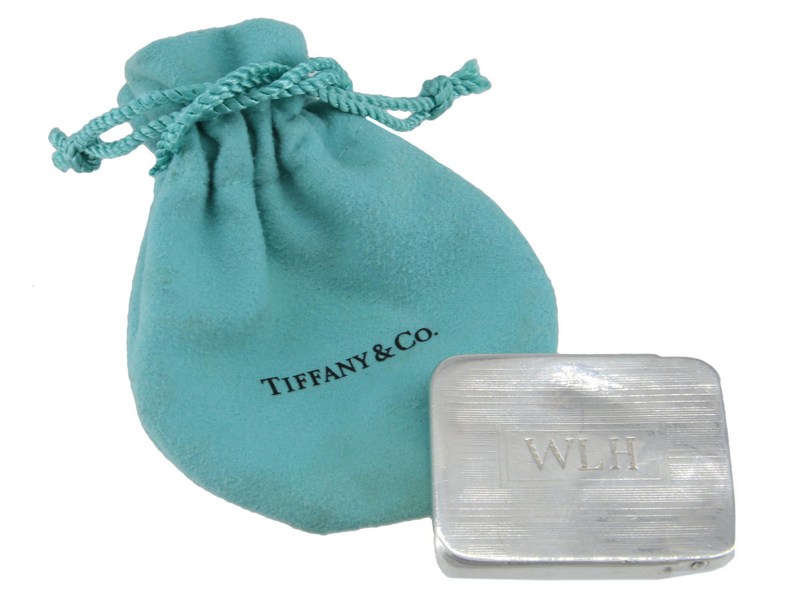 INTAGE ART DECO SILVER TIFFANY TRINKET BOX: A vintage Art Deco Tiffany and Co, sterling silver trinket box used for jewelry and pills. Hallmarked with the mark of the manufacturer and sterling on the back. With the engraving WLH on the top. Cir