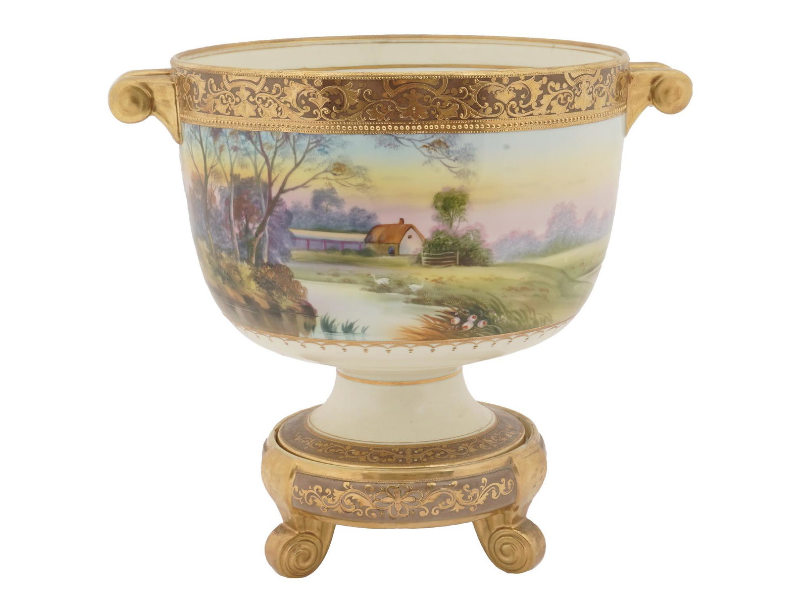 NIPPON WARE GILT PORCELAIN FLOWER POT WITH STAND: A vintage Japanese porcelain planter. The flower pot has two decorative handles and a legged stand covered with golden ornaments. The body of the planter is hand-painted with a rural landscape depicti