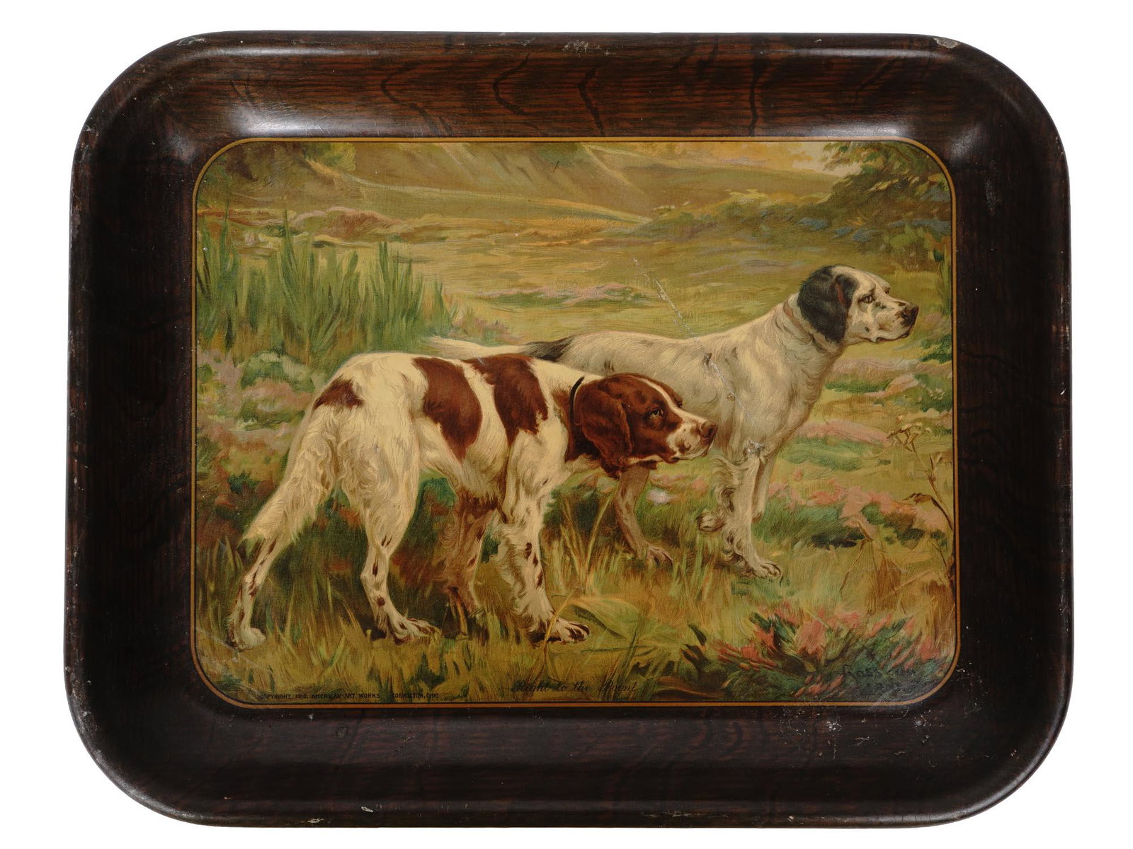 ANTIQUE 1910 AMERICAN ART WORKS TIN TRAY W DOGS: An antique painted tin serving tray. The rim of the item imitates a wooden surface. The central part represents two hunting dogs in the field. Insciription Copyright 1910, American Art Works, Coshocto