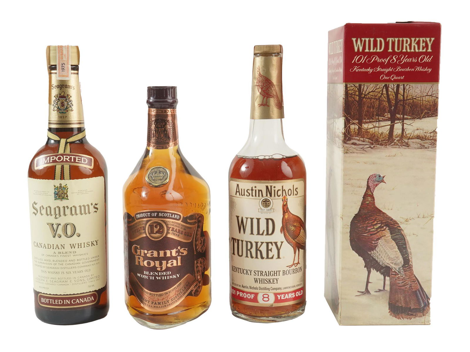 4 SEALED ALCOHOL BOTTLES IOB WILD TURKEY SEAGRAMS: A set of four vintage sealed whisky bottles in original boxes. Two bottles of Austin Nichols Wild Turkey 101 Proof 8 Years Old Kentucky Straight Bourbon Whiskey. A bottle of Grant's Royal Blended Scot