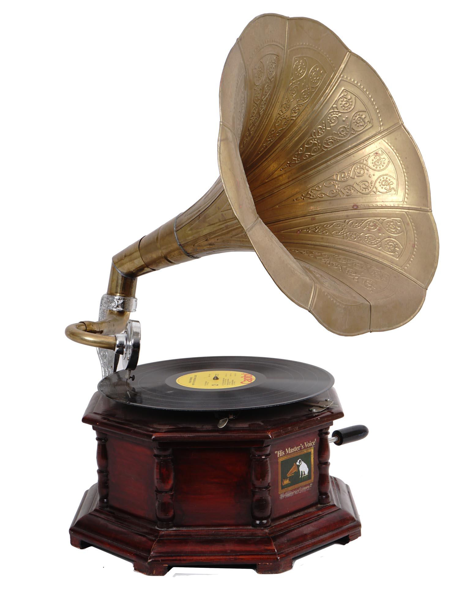 HIS MASTER'S VOICE GRAMOPHONE WITH BRASS TRUMPET: A vintage portable gramophone by HMV. The player has an octagonal mahogany case and a silver and golden brass trumpet with ornamental metalwork. The gramophone comes with a 78 RPM disc. Hallmark is on