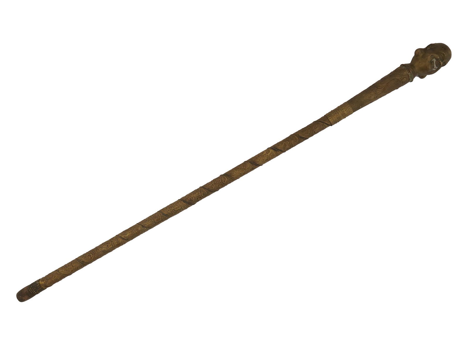 VINTAGE MID CENTURY ASIAN BRASS SWORD CANE: A vintage Asian brass cane with a steel sword hidden inside, which can be accessed by unscrewing the handle. The surface is decorated with embossed floral motifs. The head of the cane is made of brass