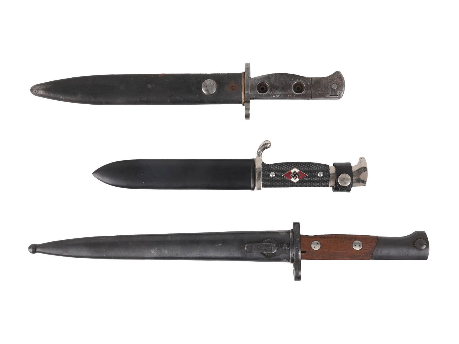 THREE GERMAN AND SOVIET DAGGERS WITH SHEATHS RZM: A set of three daggers. All items come with black leather sheaths. The bayonet with the wooden handle was made in Yugoslavia. An RZM knife is engraved with the inscription Blood and Honor and has a Na