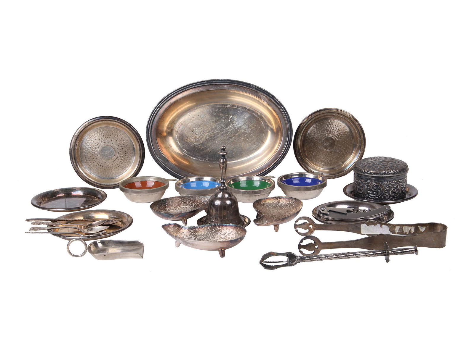 LARGE LOT OF VINTAGE AND ANTIQUE SERVEWARE ITEMS: A large lot of vintage and antique serveware items including four chased dessert spoons, four cups enameled inside, round plates, a bell, ice tongs marked TWA, a scoop marked I. Kassoy, a silver chase