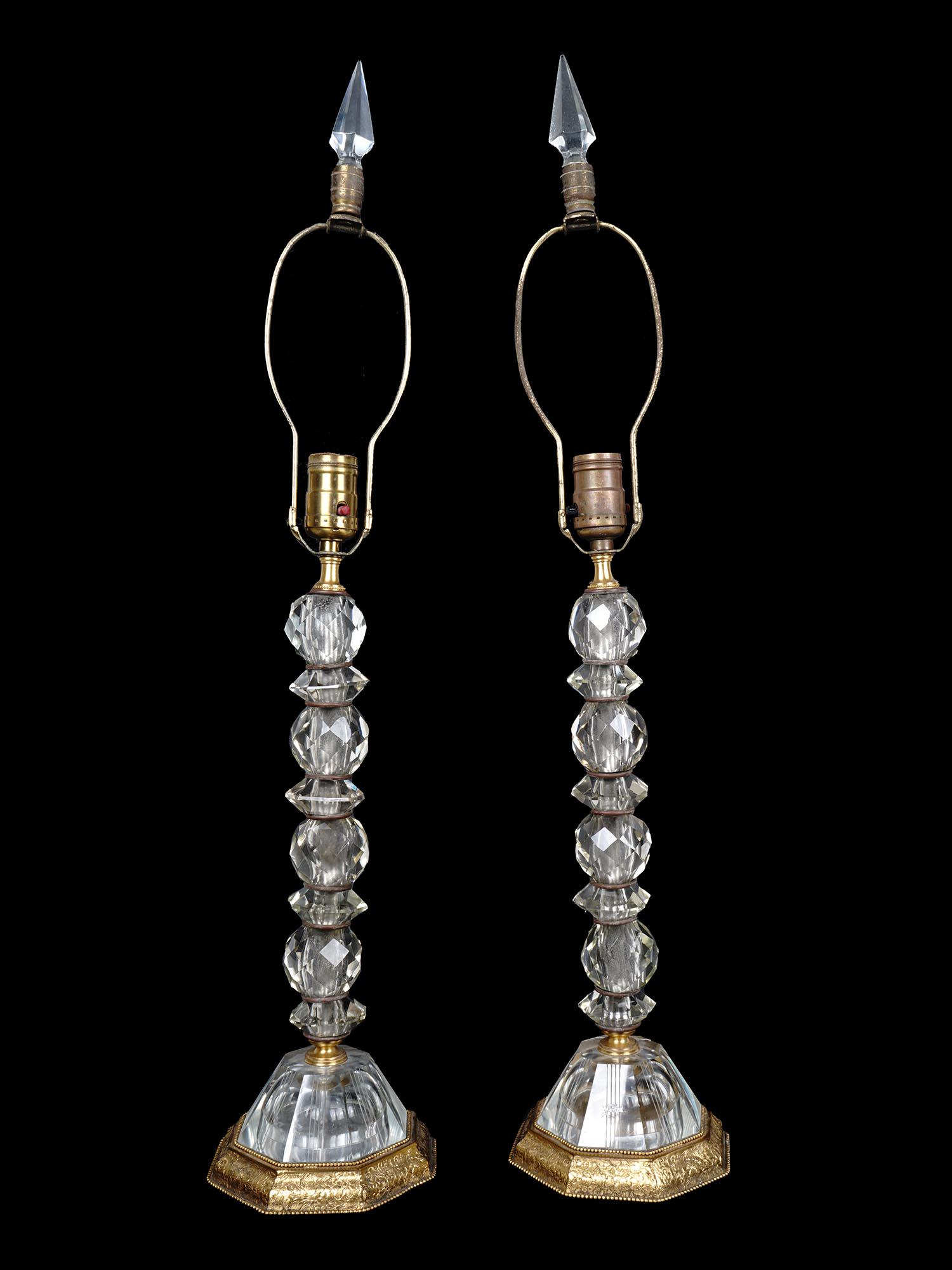 ANTIQUE PAIR BRONZE AND FACETED GLASS TABLE LAMPS: Antique pair of identical vintage table lamps with a single light socket and a lamp harp. The base and shaft of the lamps are made of bronze, with faceted glass spheres mounted on them. The bronze par