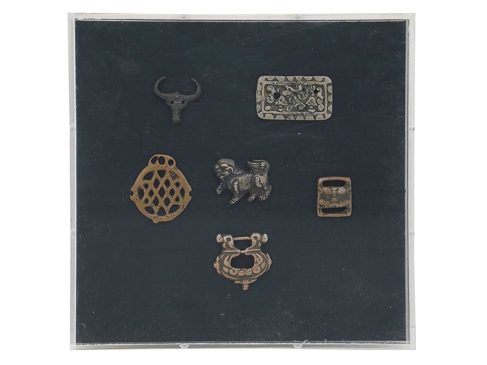 GLASS DISPLAY W ANCIENT METAL AMULETS AND BUCKLES (1 of 6)