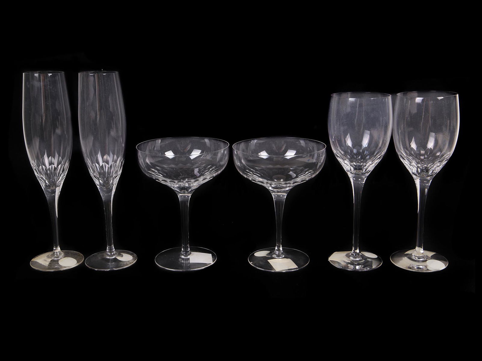 VINTAGE ORREFORS CHAMPAGNE AND WINE GLASSES: A set of six vintage glasses including four champagne glasses and two dessert wine glasses, possibly Orrefors from the 20th century. One of the wine glasses has a small chip. Provenance: Christie's Au