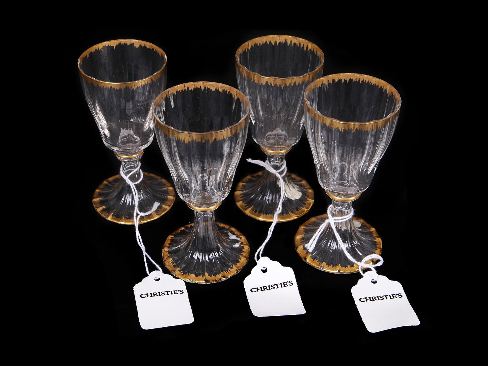 VENETIAN PARCEL GILT DESSERT WINE GLASS SET: A set of four vintage Venetian parcel gilt decorated dessert wine glasses. Circa the 20th century. Collectible glassware and drinkware. Provenance: Christie's Auction, October 6th, 2005. Sale 1558. Di