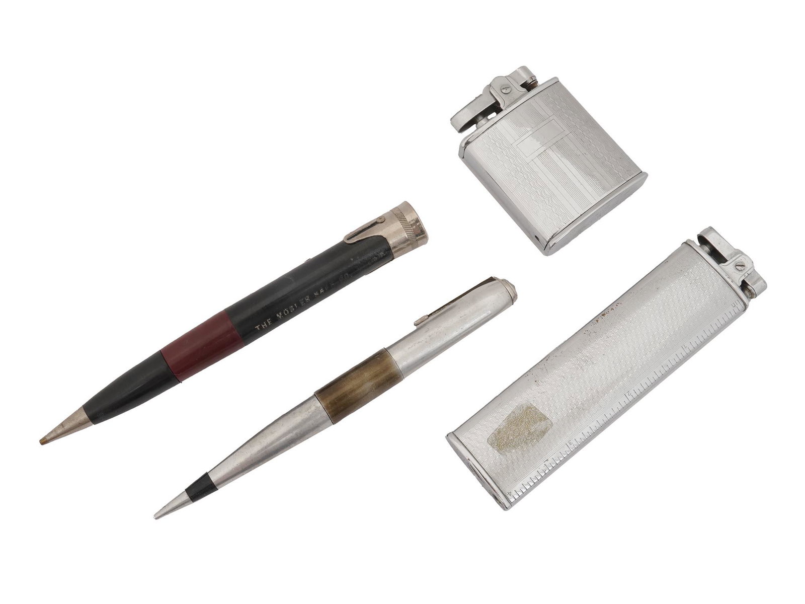 VINTAGE JAPANESE LIGHTERS AND TWO PEN LIGHTERS: A vintage Japanese metal ashtray and cigarette lighter combo by Suntos and a vintage Japanese cigarette lighter by ATC De Luxe, decorated with engraved designs. Also, there are two vintage novelty pen