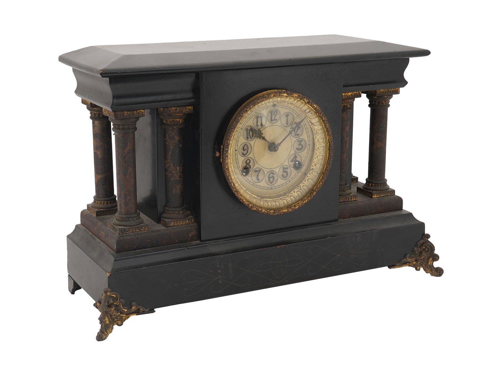 ANTIQUE AMERICAN COLUMNS PENDULUM MANTEL CLOCK: An antique American Seth Thomas Clock Co. Adamantine style mantel clock with a pendulum ball. The clock is adorned with Neoclassical columns to the sides. A cream tone dial with black Arabic numerals