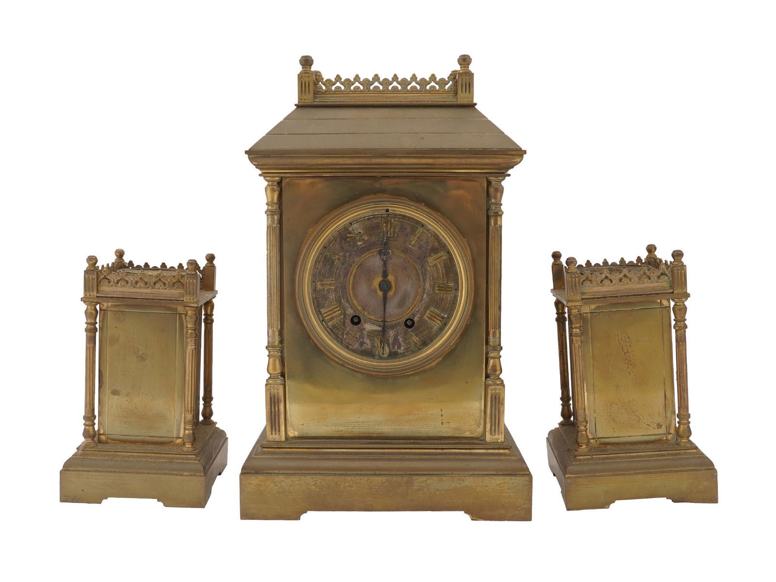 VINTAGE BRASS MANTEL CLOCK W SIDE CANDLE HOLDERS: A vintage set of a brass mantel clock and a pair of side candle holders. The items are made in a Victorian style and adorned with figural scrollwork borders on the top. An etched dial with brass Roman