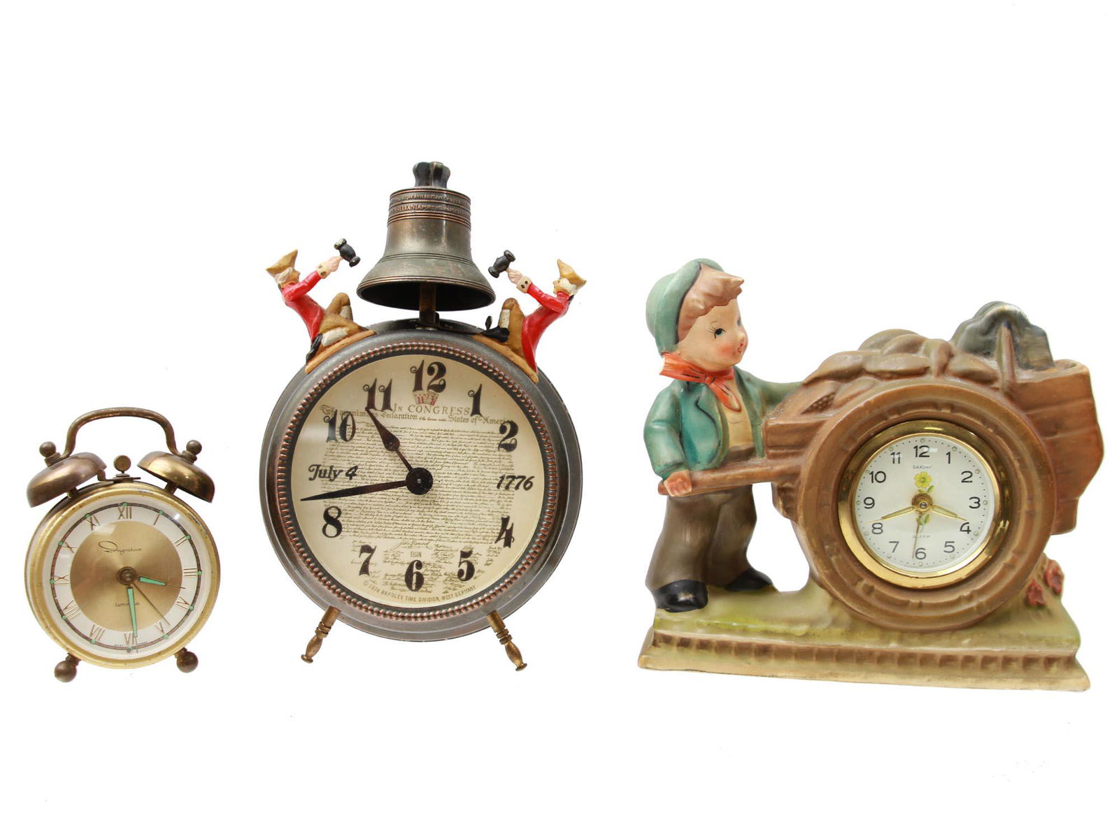 A LOT OF THREE VINTAGE WEST GERMANY CLOCKS: A set of three vintage clocks: 1. A mid-1950s Ingraham Luminous 2-bell alarm clock, made in West Germany;2. A vintage Elgin Bicentennial Commemorative Series Liberty Hall alarm clock, July 4th, 1776 /
