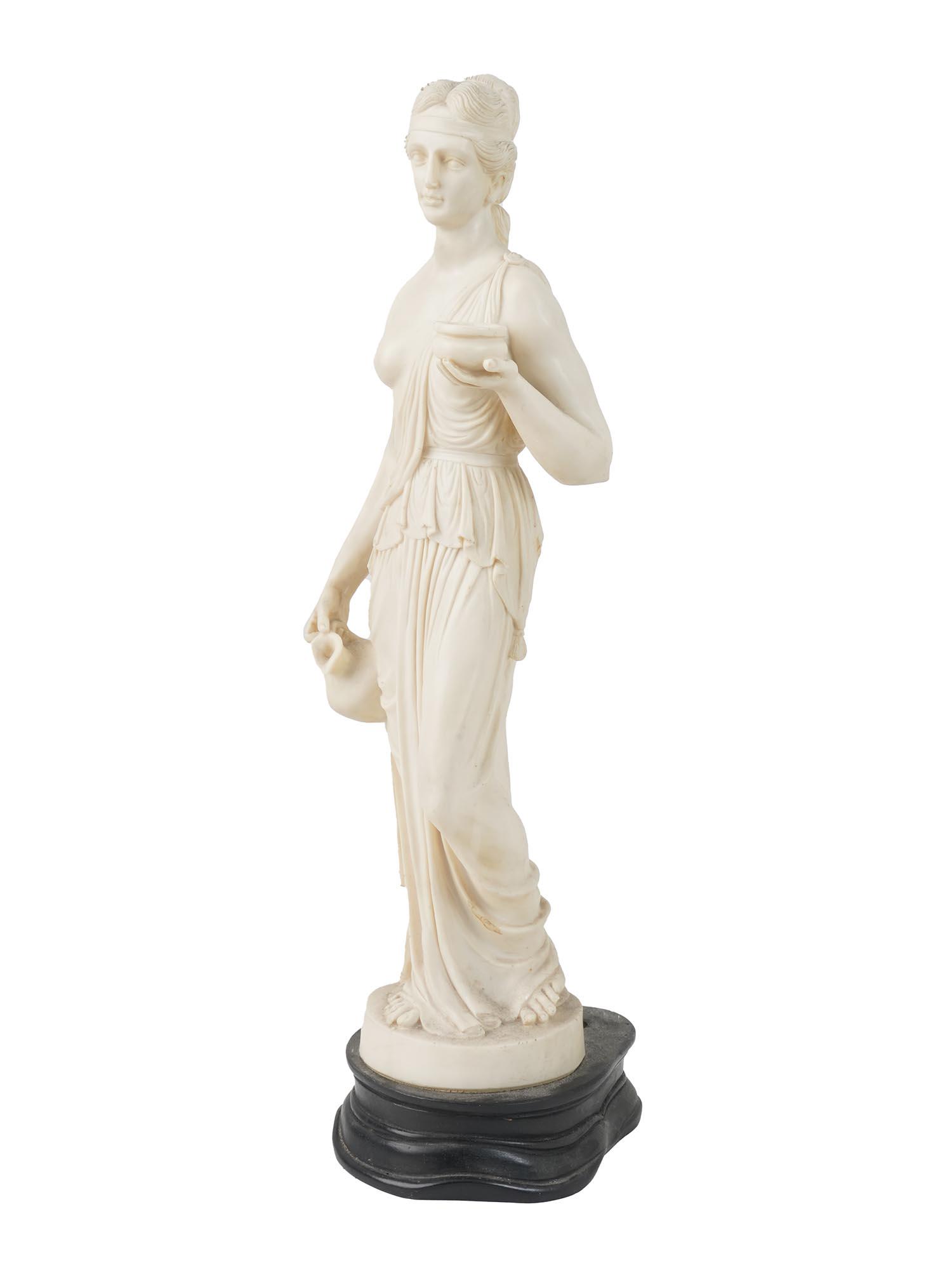 VINTAGE COMPOSITE STATUE HEBE IN NEOCLASSIC STYLE: A sculpture depicting the Greek goddess of youth Hebe made of reconstituted marble composed of resin and marble dust. Signed L.T, P.A.T. Reproduction of the Neoclassicist sculpture of Hebe by Bertel T