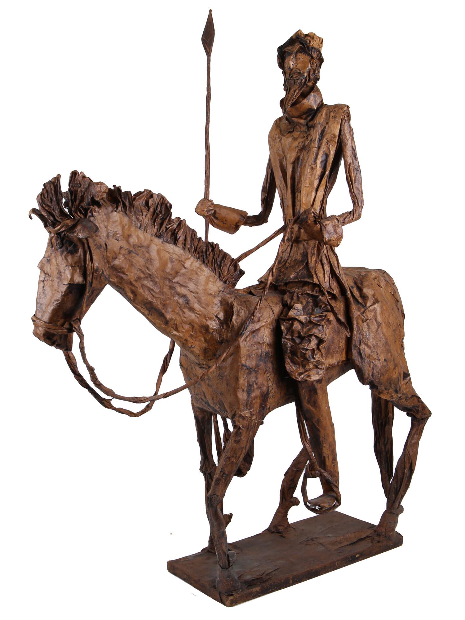 DON QUIJOTE ON HORSEBACK PAPIER MACHE SCULPTURE: A handmade papier-mache sculpture painted brown. Papier-mache is a composite material consisting of paper pieces and textiles, bound with glue. An iconic depiction of Don Quixote, the main character o