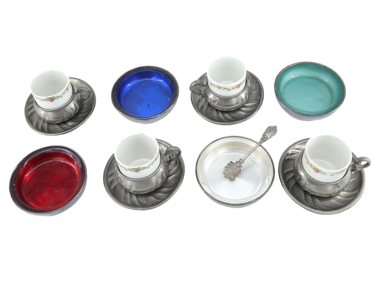 VINTAGE SILVER, PEWTER AND PORCELAIN TABLEWARE: A lot of vintage collection of tableware including salt cellars, plate bowls, cups, case, and a spoon. The first: four salt cellar set FB Rogers Silver co. silver plate bowls adorned with enamel in co