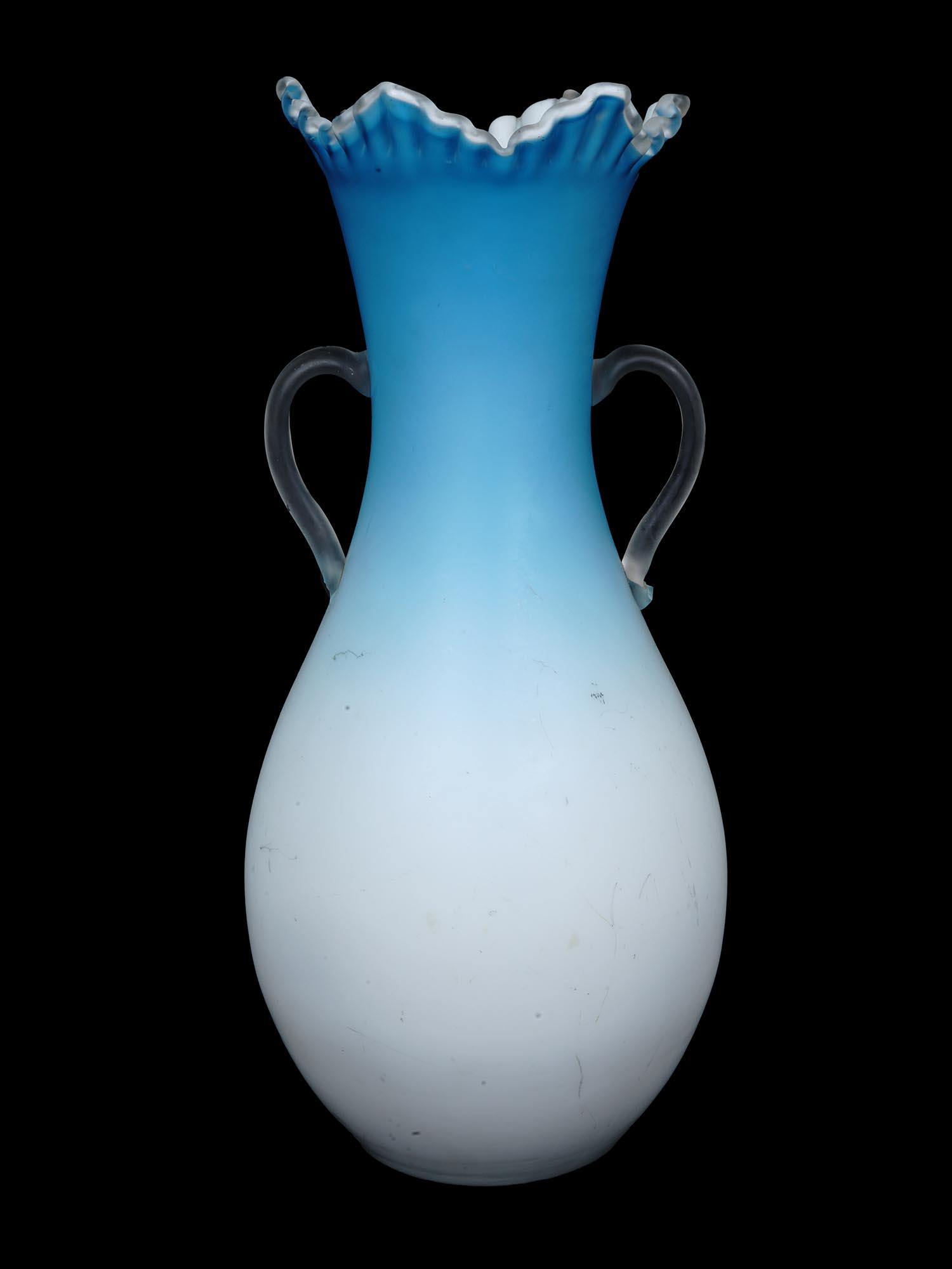 LARGE TRANSLUCENT BLUE WHITE GLASS VASE W HANDLES: A large Italian Murano style amphora shaped translucent blue and white glass vase. The vase is adorned with a pair of clear handles and a fluted neck. Unmarked. Circa: 20th century. Antique and Vintag