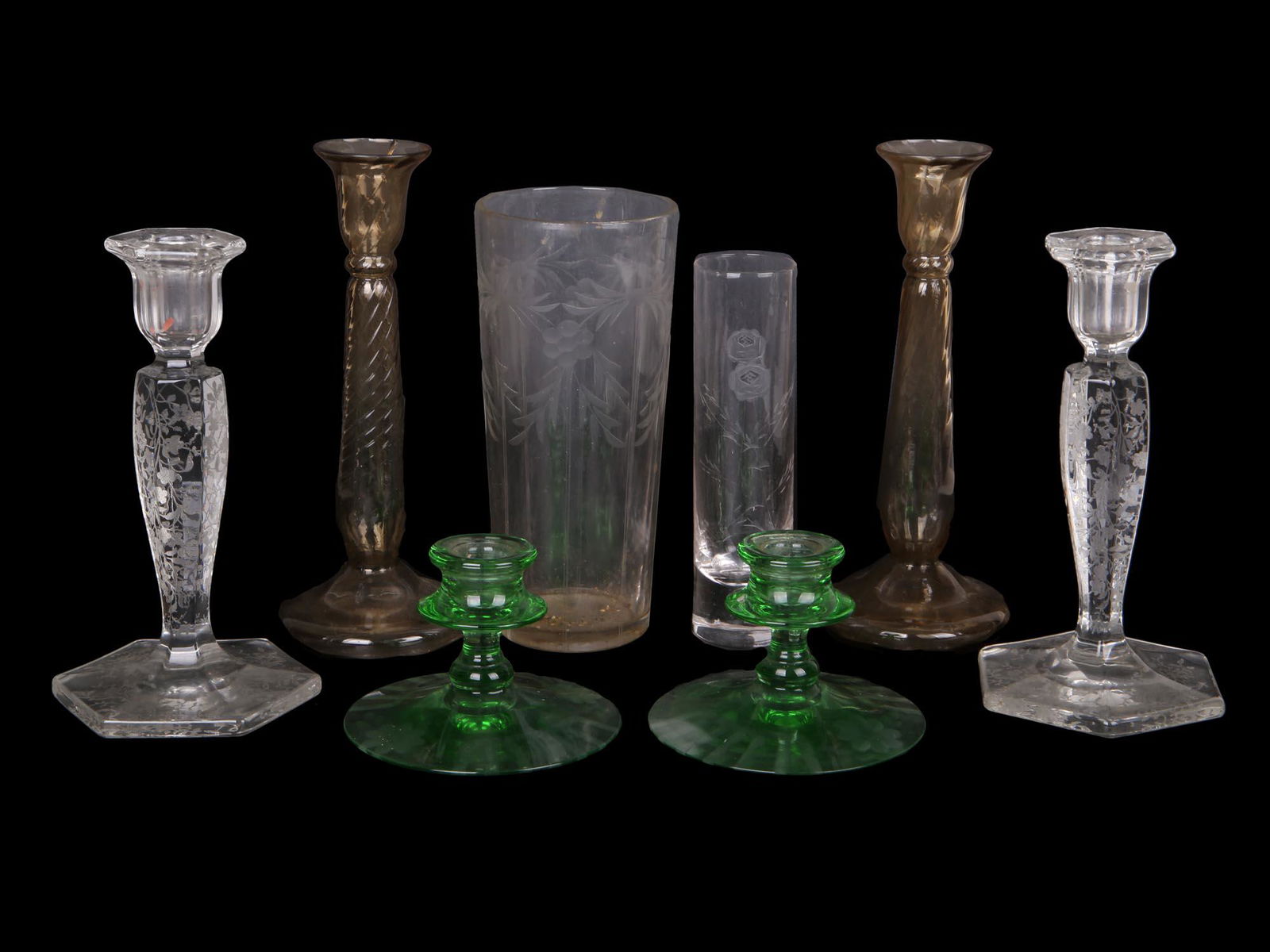 GROUP OF EIGHT CRYSTAL GLASS CANDLE STICKS VASES: A group six crystal glass candlesticks and vases. The group includes a pair of tall hand blown candlesticks engraved with a floral pattern, a pair of tall bronze tone glass candleholders adorned with