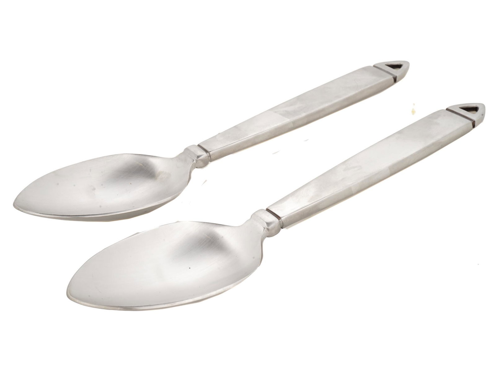 TWO LISA JENKS NOTCH LUNT STAINLESS STEEL SPOONS: A pair of Lunt stainless steel serving spoons, the notch pattern. Designed by Lisa Jenks. Marked. Made in Korea. Modern Kitchenware and Flatware For Collectors. Dimensions: L: 10 in. All measurements 