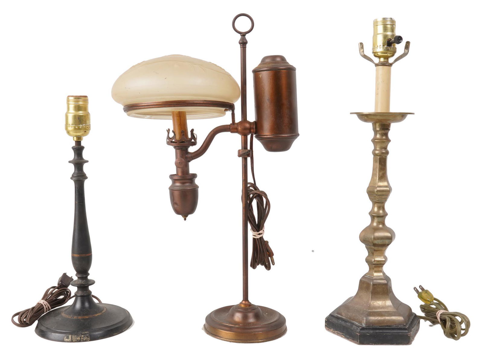 ANTIQUE STUDENT LAMP AND BRASS CANDLESTICK LAMPS: A lot of three electric table lamps dating back to the first half of the 20th century. A dark-toned candestick lamp with a single light socket. A faceted brass lamp with a single light socket. A coppe
