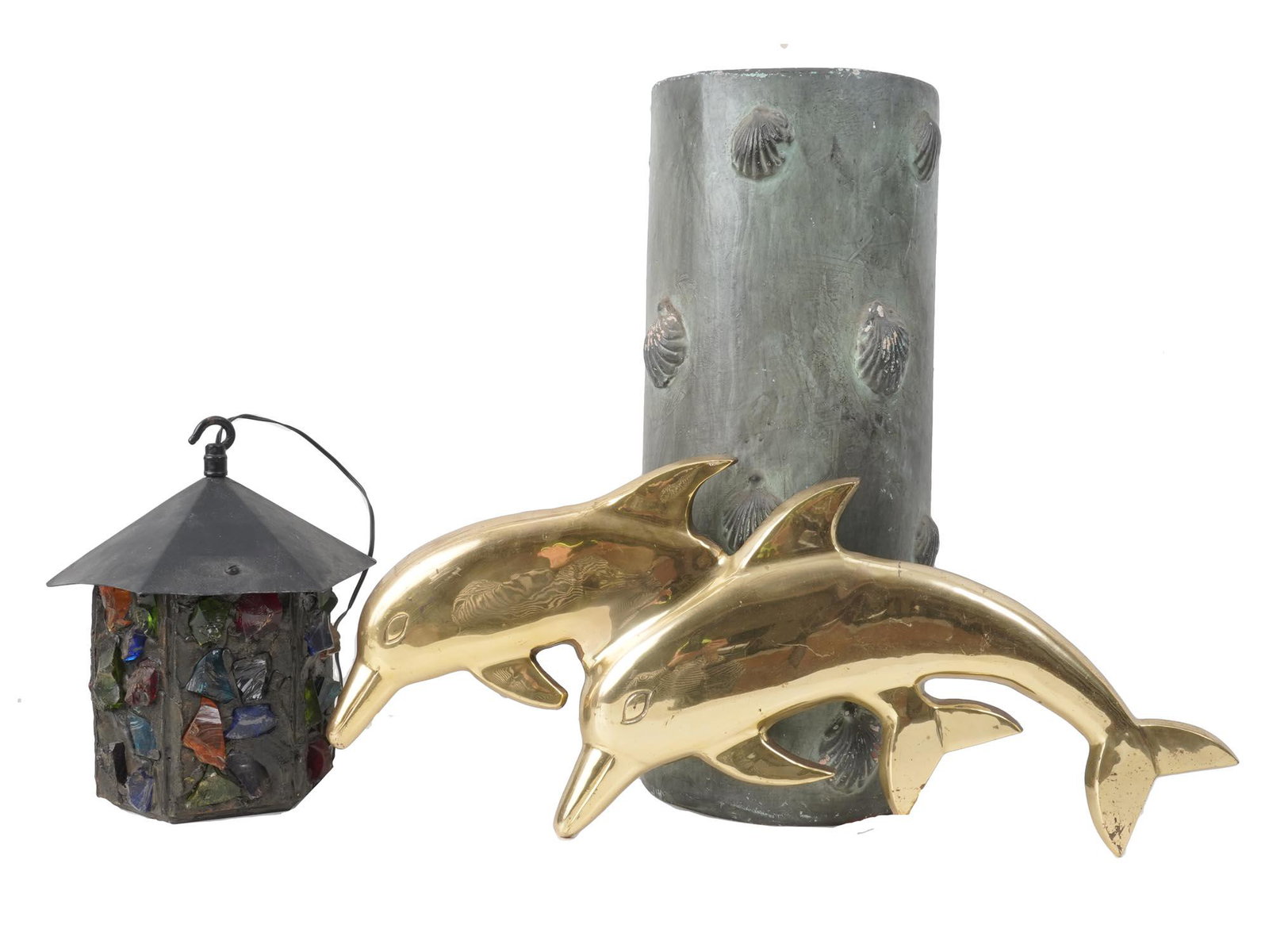 VINTAGE UMBRELLA POTTERY STAND LAMP AND WALL DECOR: A pair of vintage brass wall mounted dolphins, a hand made metal lantern hanging on a hook and decorated with colorful glass pieces, a vintage pottery umbrella stand decorated with seashells. Wall art