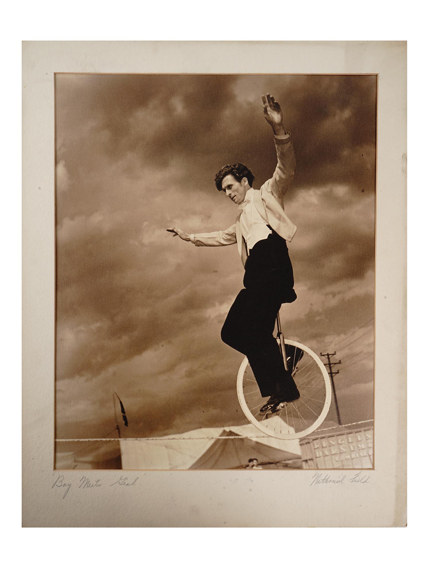 AMERICAN CIRCUS ARTIST PHOTO BY NATHANIEL FIELD: Nathaniel Field, American, 20th century, rare black and white photograph mounted on a laid paper depicting a male circus artist going through a rope on one wheel titled Boy Mute Girl. Entitled and sig