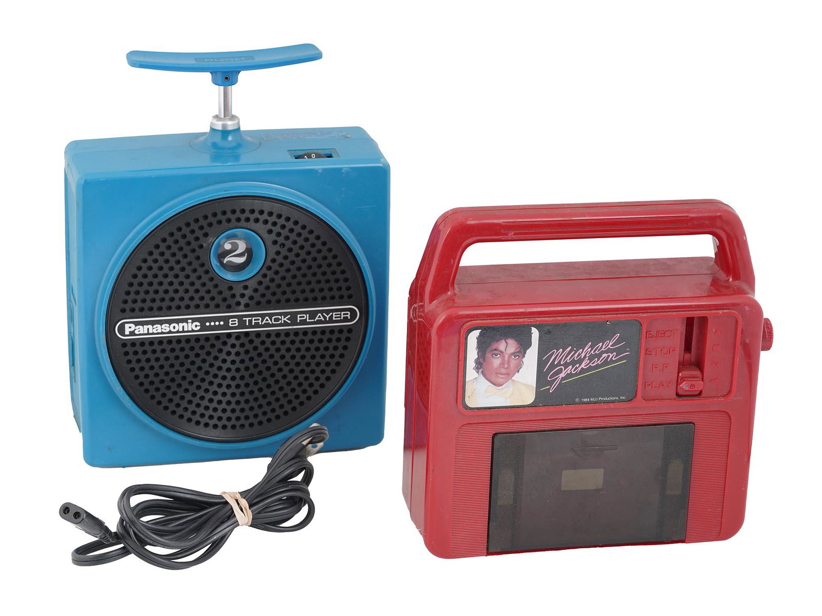RETRO 1970 1980S ELECTRONIC MUSIC PLAYER DEVICES: The lot includes a vintage 1984 Vanity Fair ERTL red color Michael Jackson cassette player and a 1975 Panasonic RQ-830S blue color Dynamite portable 8-track player, made in Japan. Collectible Retro El