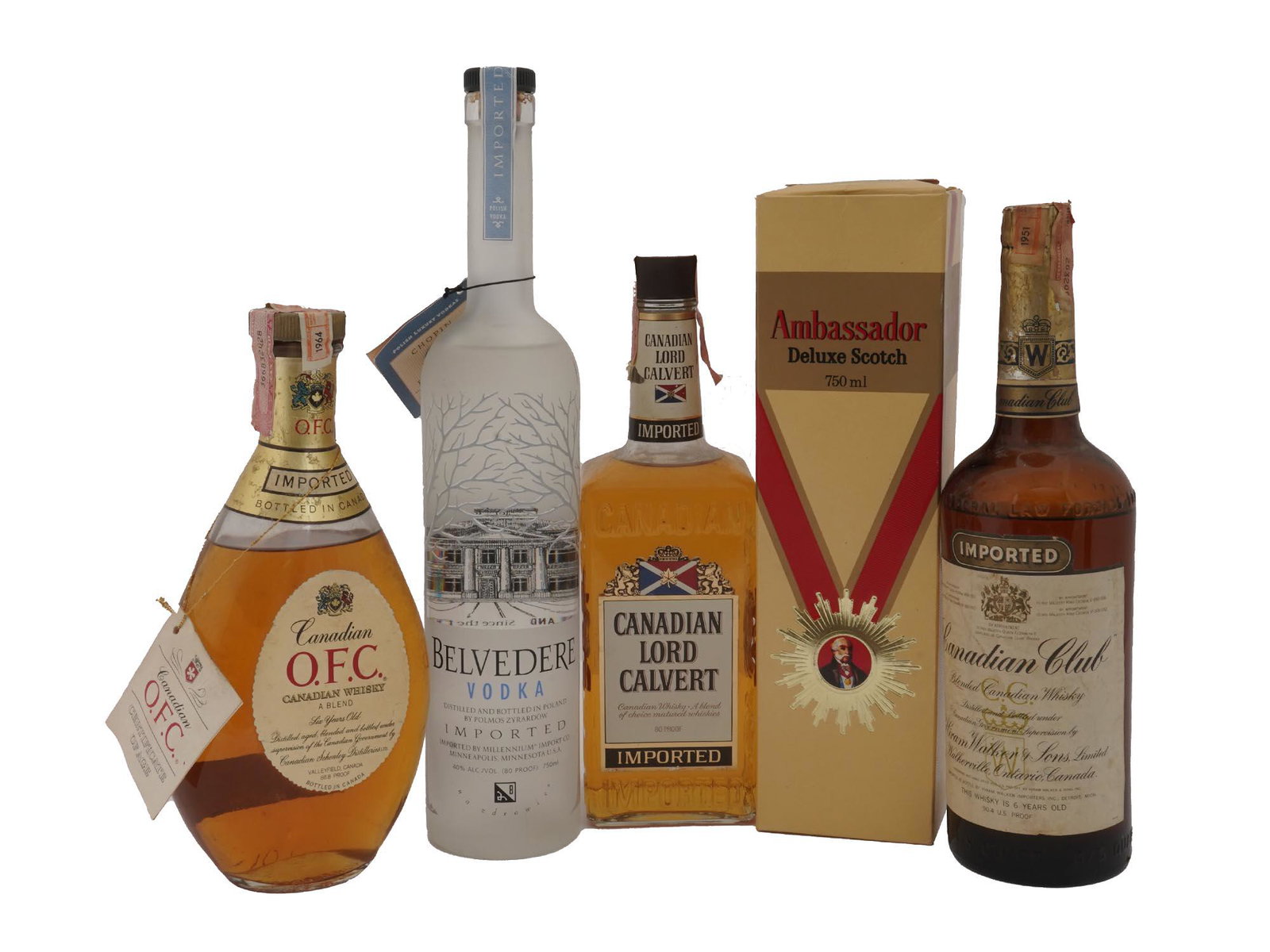 FIVE VINTAGE ALCOHOL BOTTLES SCOTCH AND WHISKY: A set of five vintage sealed whisky bottles. Imported OFC Canadian Whisky, A Blend, Six-Years Old. Imported Belvedere Vodka, distilled and bottled in Poland. Imported Canadian Lord Calvert, Canadian W