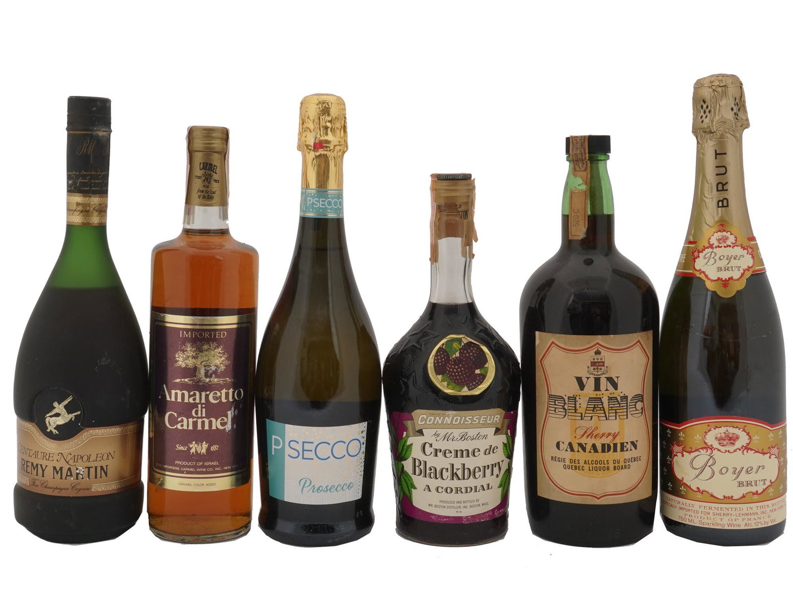 SIX VINTAGE ALCOHOL BOTTLES WHITE SPARKLING WINE: A set of six vintage sealed alcohol bottles. Choice of Connoissuer by Mr Boston, Creme de Blackberry, A Cordial. Vin Blanc Sherry Canadien. Cromwell Imports, French Boyer Brut. Imported Israeli Amaret