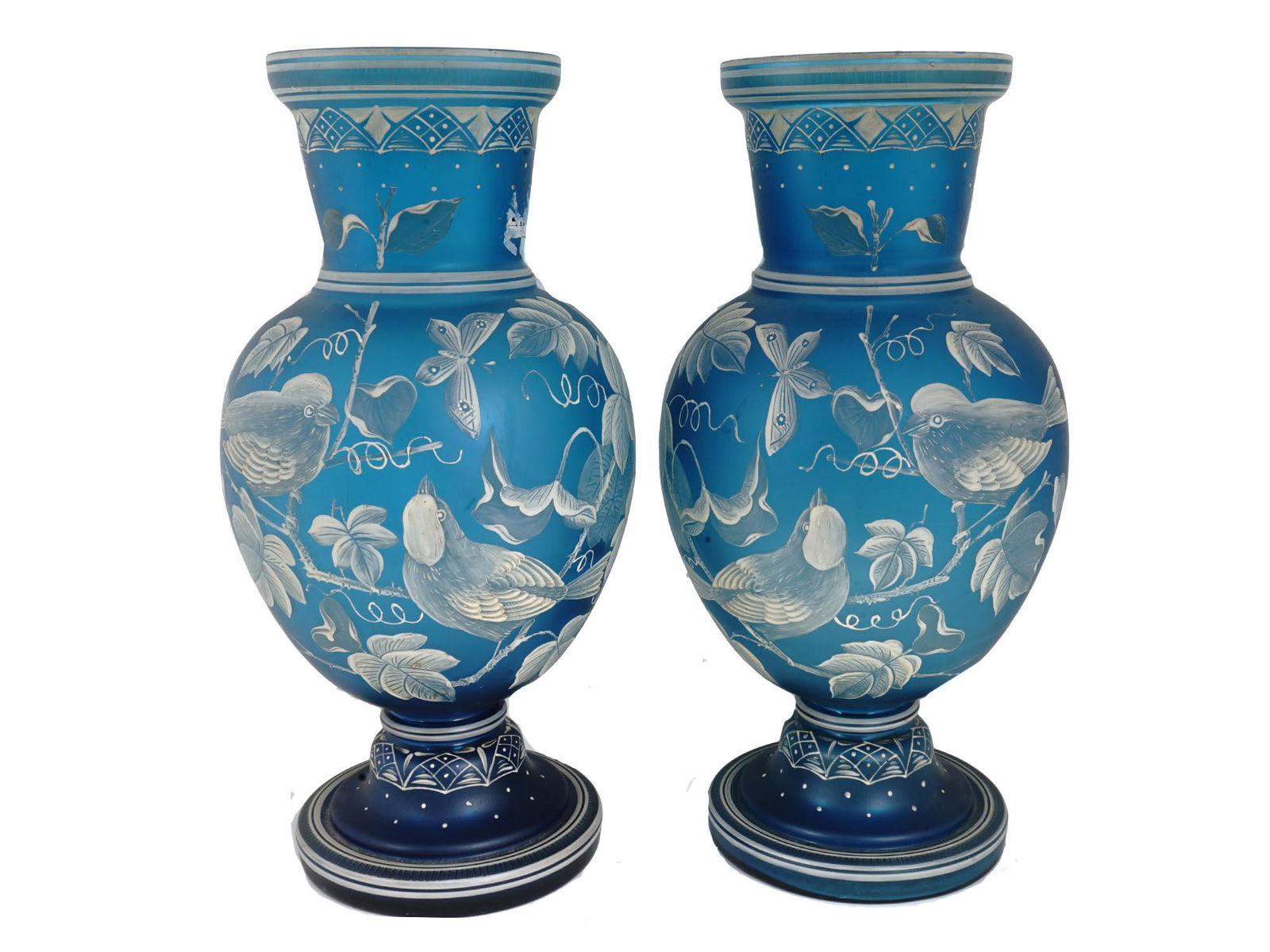 ANTIQUE CAMEO GLASS VASES ATTR. THOMAS WEBB SONS: A nice antique pair of cameo glass vases made circa 1890, unmarked, attributed to Thomas Webb and Sons. Of a baluster form, made of frosted Prussian blue glass, with an opaque white winter overlay fin