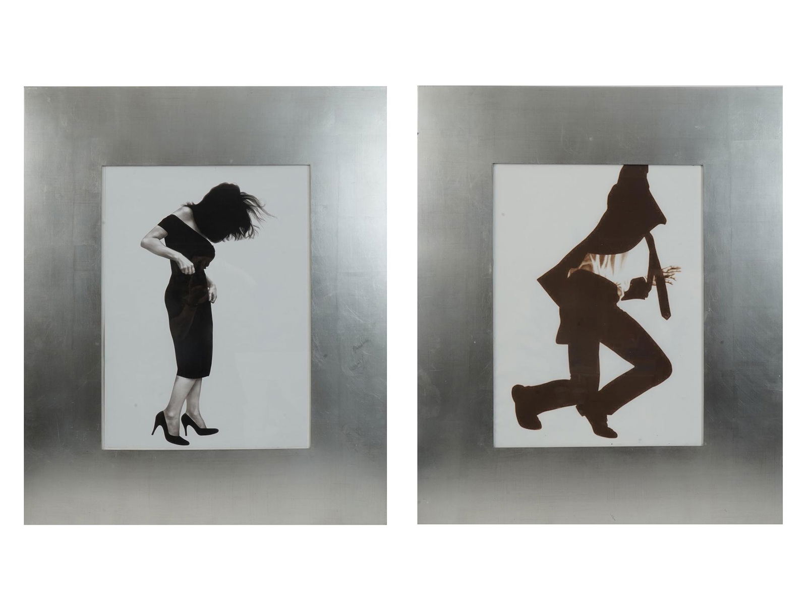 TWO PRINTS FROM MEN IN THE CITIES BY ROBERT LONGO: A lot of two black and white prints in silver frames. The pictures depict a man and a woman without faces. Titled Gretchen, 1980 and Frank, 1981. From the Men in the Cities graphic series by Roberto L