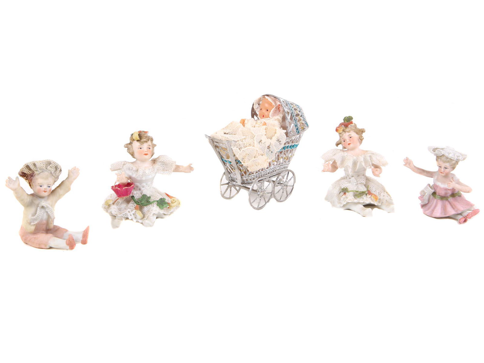 ANTIQUE VICTORIAN BISQUE PORCELAIN DOLL FIGURINES: A set of antique Victorian bisque porcelain little girl figurines. One is in a pram. Some marled with a model number. Made in Germany. Circa late 19th century. Dimensions: N/A
