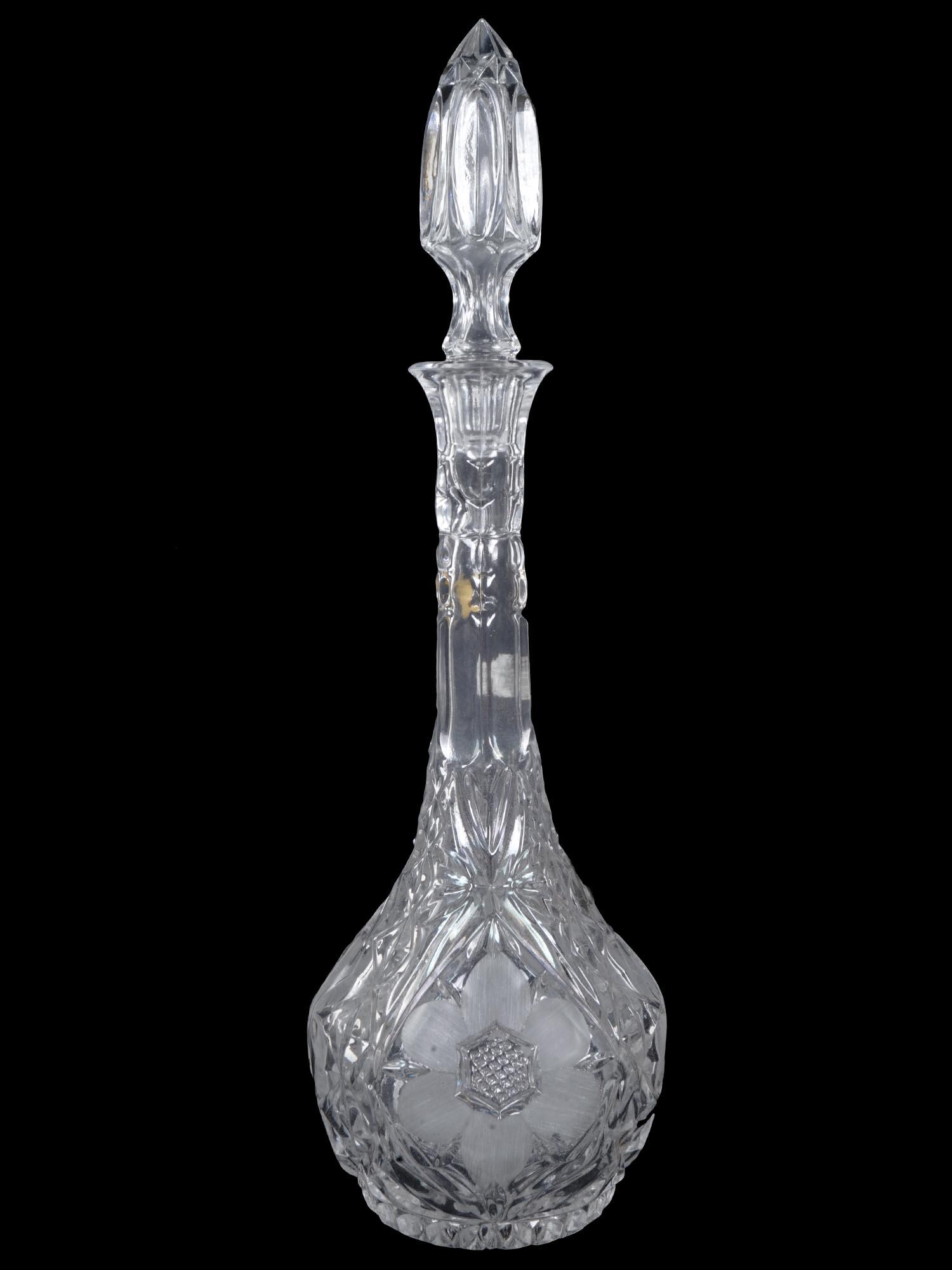 LARGE CUT AND ETCHED GLASS DECANTER WITH STOPPER: A cut glass decanter with a large stopper. The bottle has a rounded bottom and a long narrow neck. The piece has an etched floral design. Collectible Crystal Tableware And Decor. Dimensions: H 16 3/4