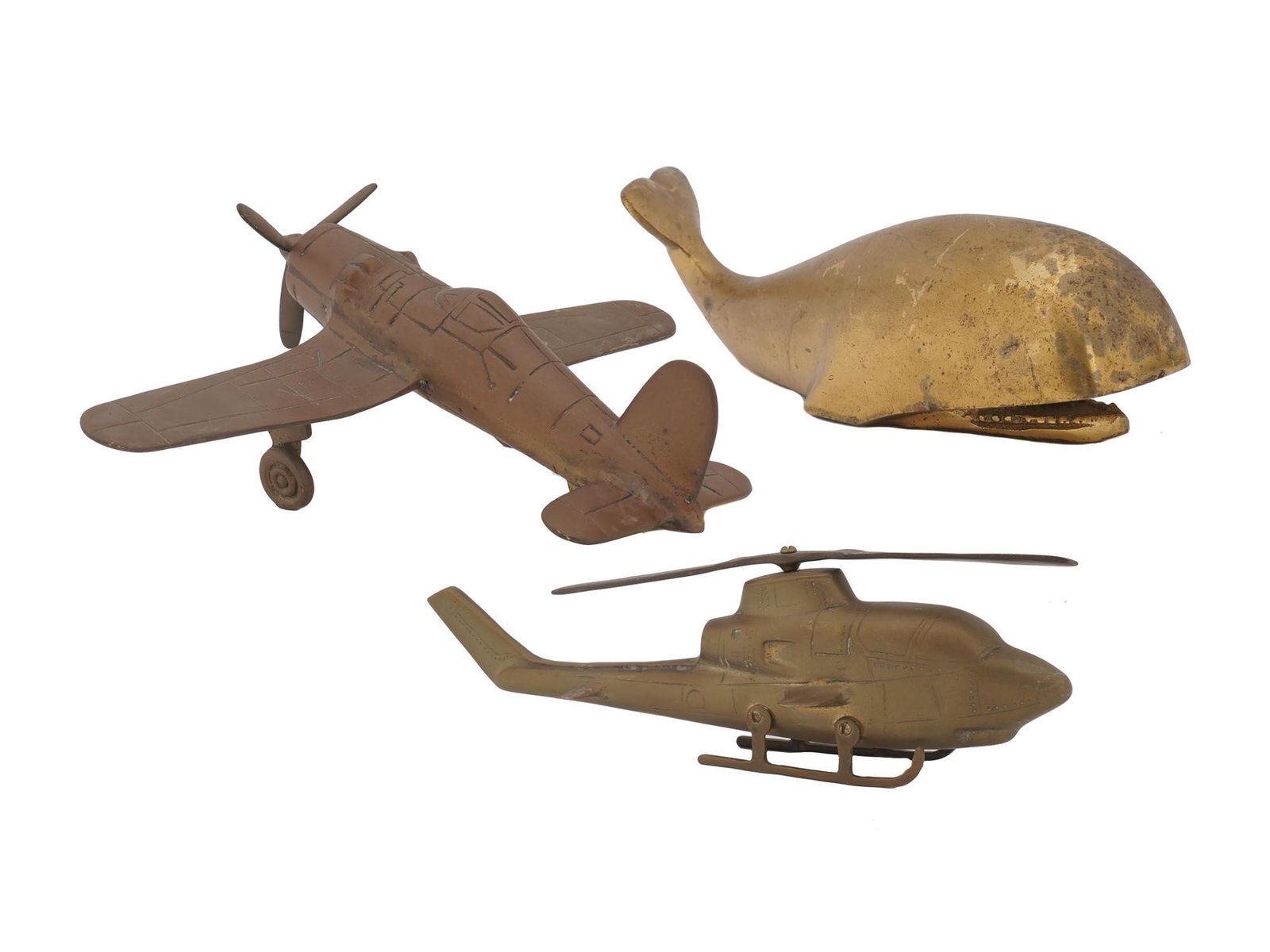 MID CENTURY AMERICAN SOLID BRASS MODELS: Two mid century modern Hollywood Regency style solid brass airplane and helicopter models. And a vintage brass whale figurine working as a paperweight statue. Circa the mid 20th century. Vintage Brass