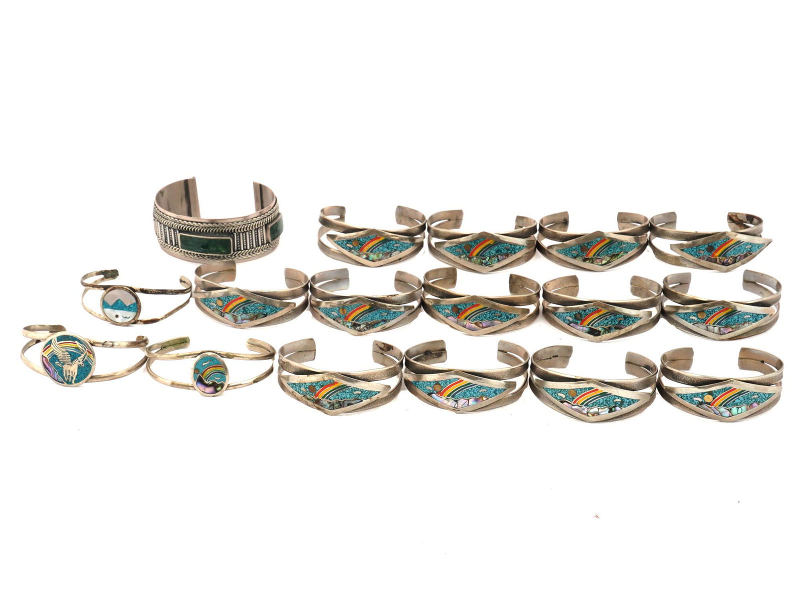 MEXICO ALPACA JEWELRY WITH CRUSHED STONE INLAY: A collection of 17 vintage Mexican silver cuff bracelets decorated with crushed stones, mother of pearl and polychrome enamel inlays. Some bracelets are marked: Mexico, Alpaca. Vintage Etchnic Jewelry