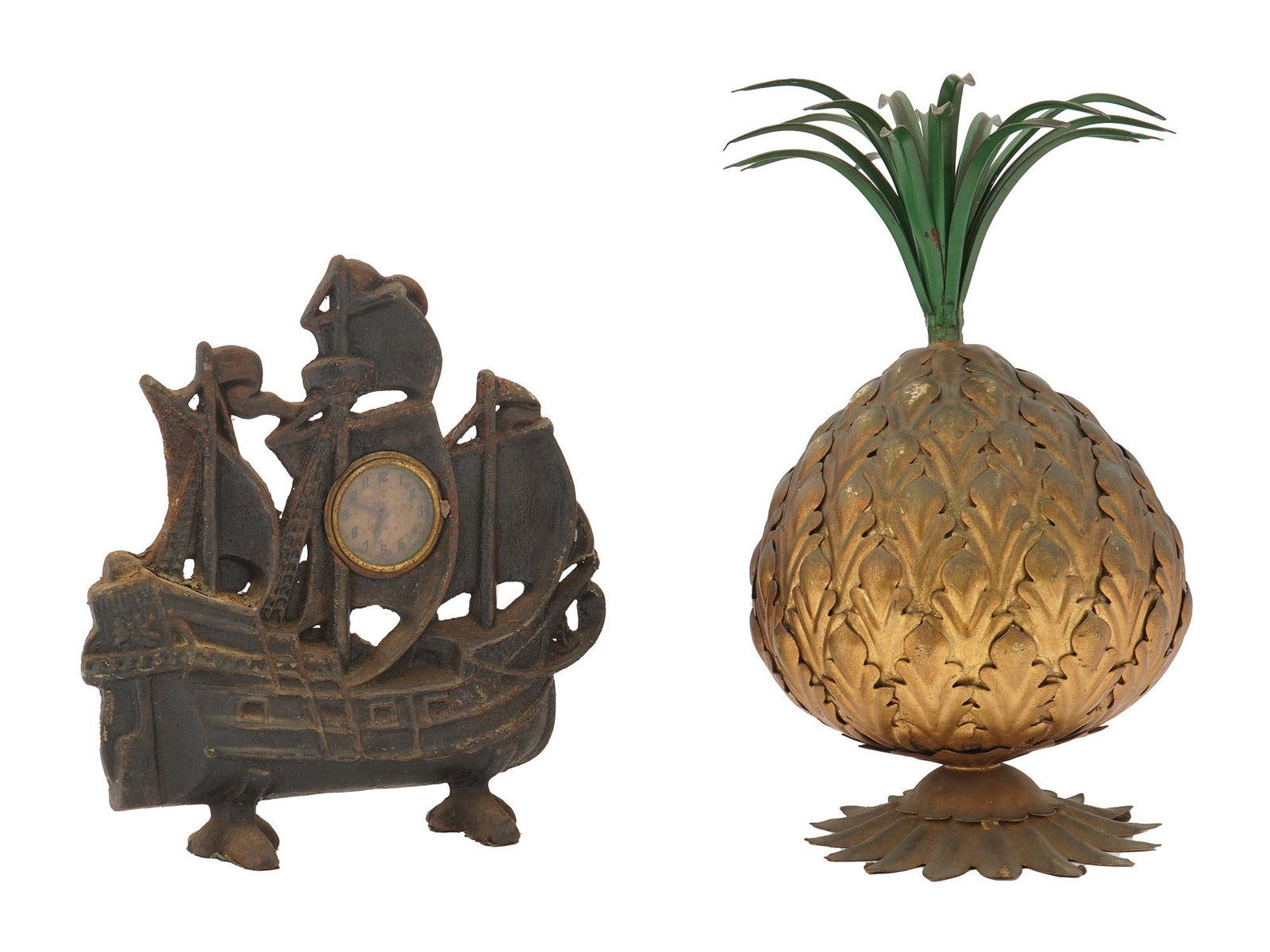 HUBLEY CAST IRON SHIP CLOCK AND BRASS PINEAPPLE: A set of two antique decor items. First. Cast iron doorstop clock by Hubley, circa 1930. The figural clock represents a sailing ship. A small dial with Arabic numerals in golden bezel is installed on 