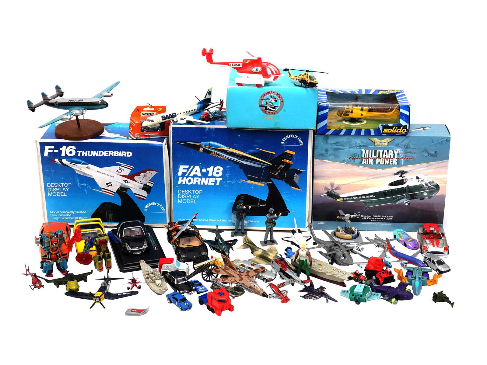 LARGE GROUP OF MINI AIR PLANES SHIPS CARS MODELS: A large collection of various miniature air planes, ships, cars, helicopters, figurines, toys models. The items are made of die cast or plastic. Several items are marked, F 16 Thunderbird Desktop Disp