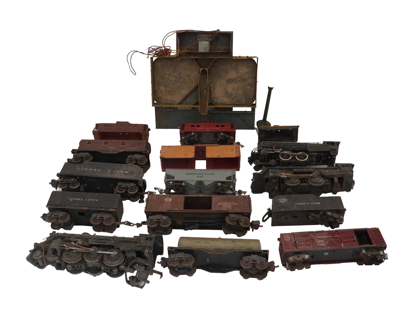 LIONEL ELECTRIC TOY TRAIN CARS AND CATTLE DOCK: A lot of vintage electric trains and accessories by Lionel Corp., an American brand established in 1900 that specializes in electric toy trains. The lot includes three locomotives, twelve freight wago