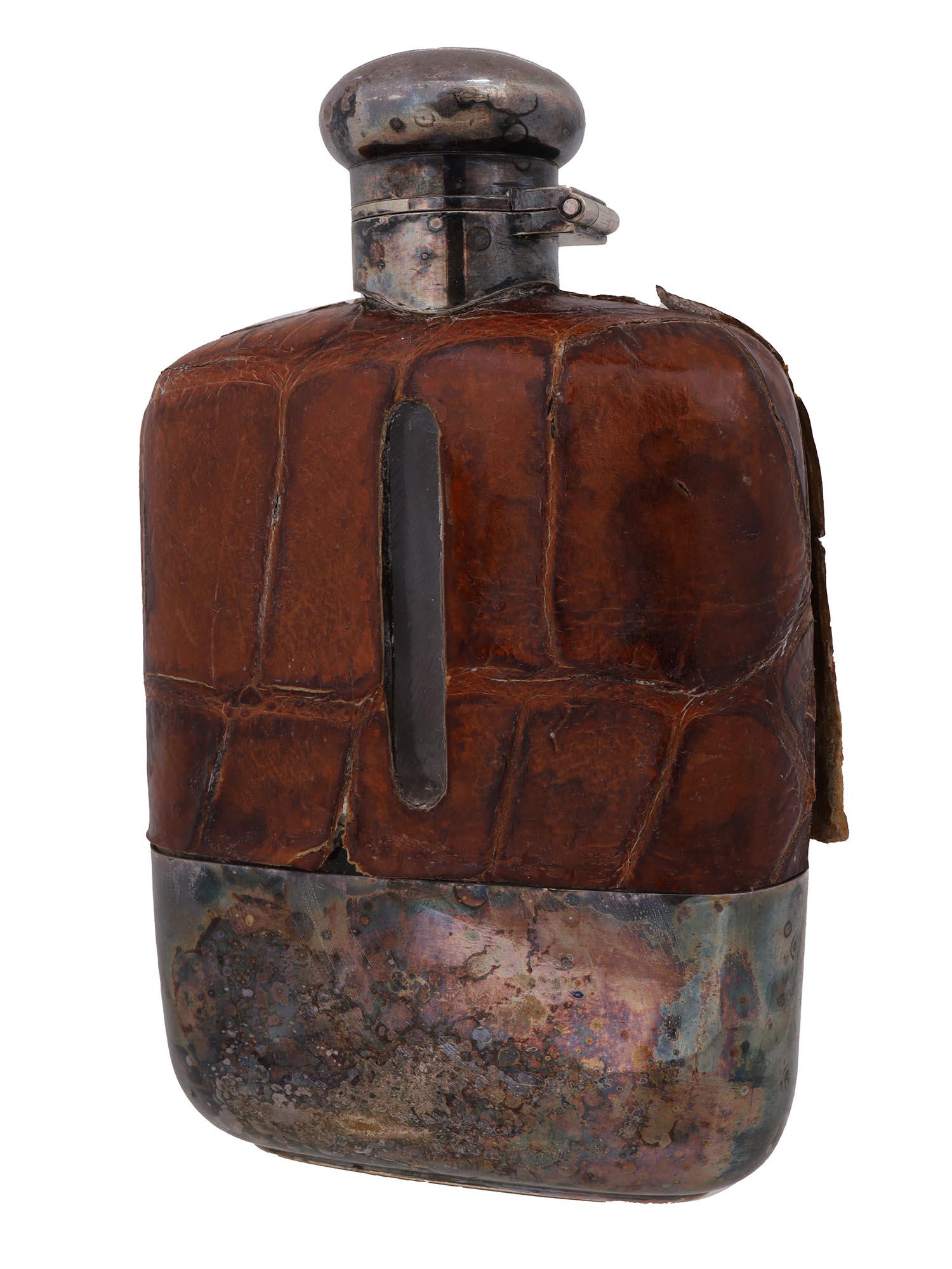 VINTAGE ENGLISH SHEFFIELD SILVER PLATED FLASK: A vintage English hand crafted silver plated whisky flask marked Sheffield to the bottom. With a leather cover to the top of the body. Circa the early mid 20th century. Vintage Alcohol Flasks And Silv