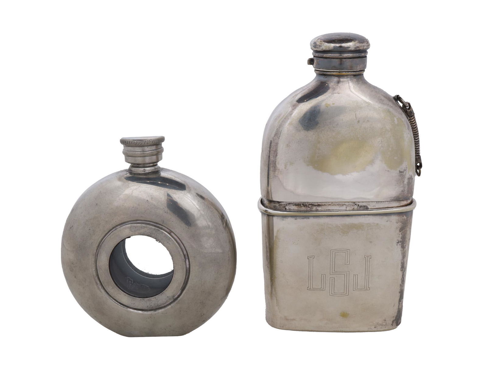 VINTAGE HAND CRAFTED SILVER PLATED WHISKY FLASKS: Two vintage hand crafted silver plated whisky flasks. One is of a round form with a hole in the center marked Pinder Bros. English Pewter Sheffield England and the other has the LSL initials to the co