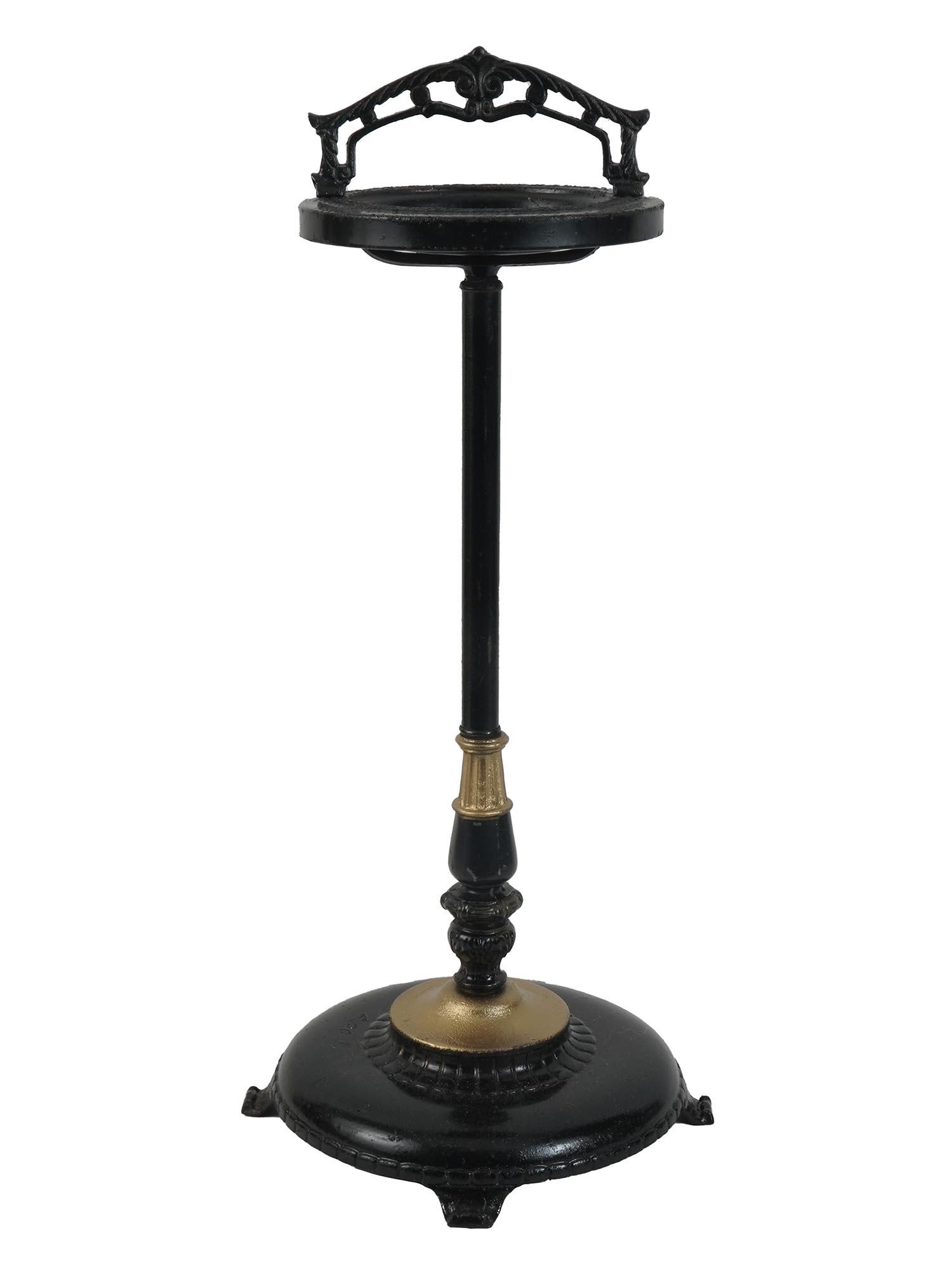 MID CENTURY BLACK AND GOLD STANDING FLOOR ASHTRAY: A 1940s black metal standing ashtray. The piece is decorated with minimalist floral decoration and golden details. Late Art Deco style. Tobacciana, Mid Century Interior Decor. Dimensions: H 27 in. All