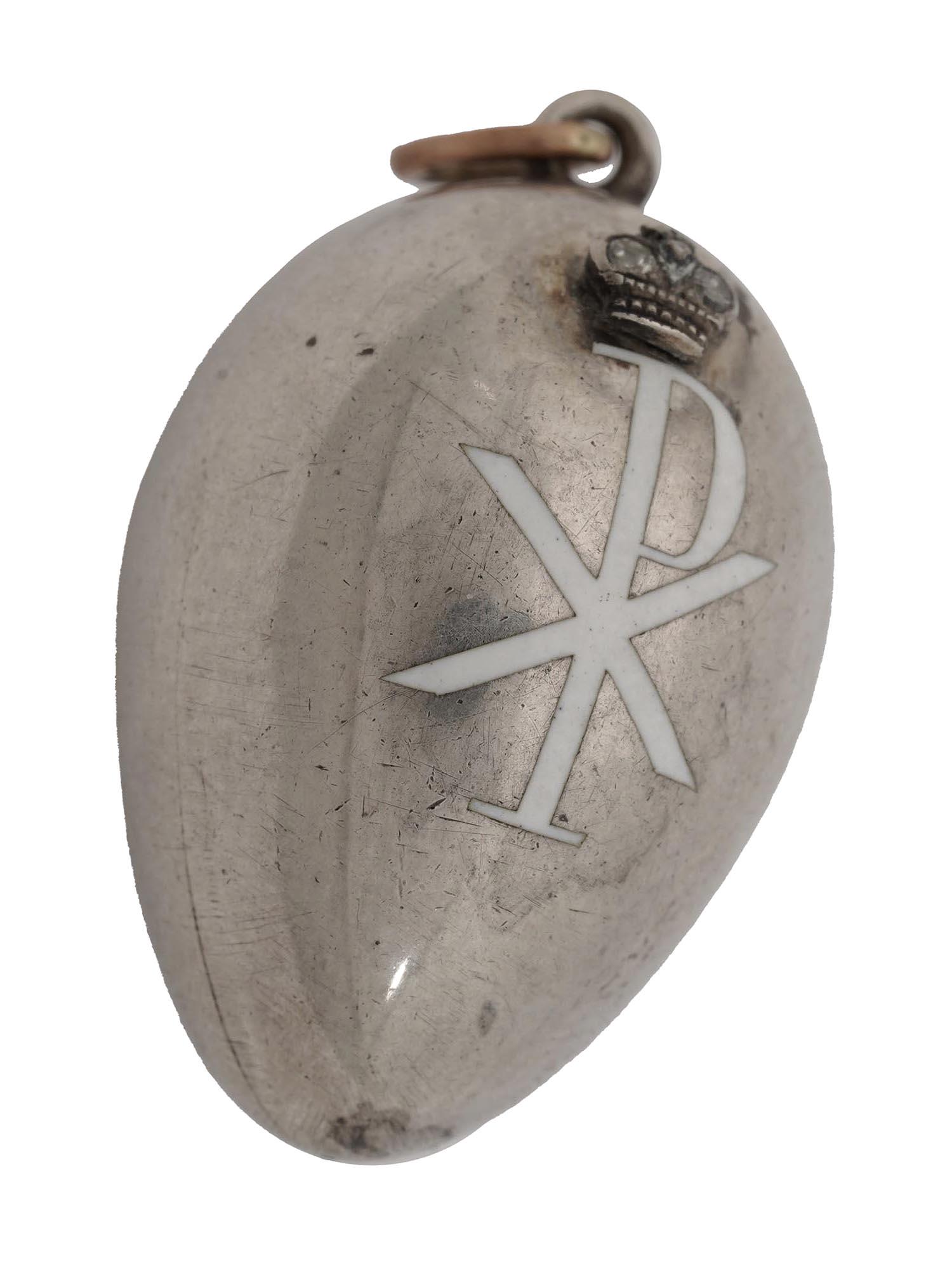 ANTIQUE RUSSIAN ORIGINAL CARL FABERGE EGG PENDANT: A Carl Faberge antique Russian miniature egg pendant made of silver and gold, decorated with white enamel Cyrillic letters RH under the relief Imperial crown srt with two round cut diamonds. Marked on