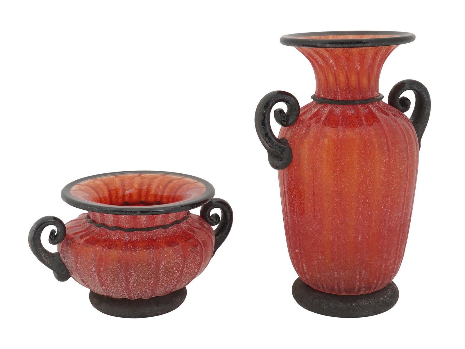 RED MURANO GLASS VASE AND FLOWER POT WITH HANDLES: A pair of Italian Murano glass decor pieces, a tall vase and bulbous cachepot with a matching design. The items are made of red glass with a fluted surface. The flattened neck, figurative handles, and