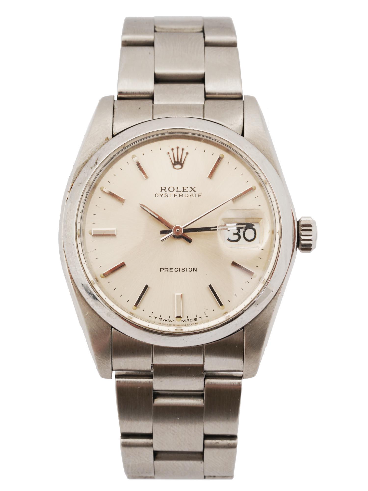 ROLEX OYSTERDATE PRECISION STAINLESS STEEL WATCH: A 1960s Swiss made Rolex Oysterdate Precision hand wind mens wrist. Stainless steel silver dial with raised baton hour markers, outer minute divisions. Steel hands and center seconds. Date calendar at