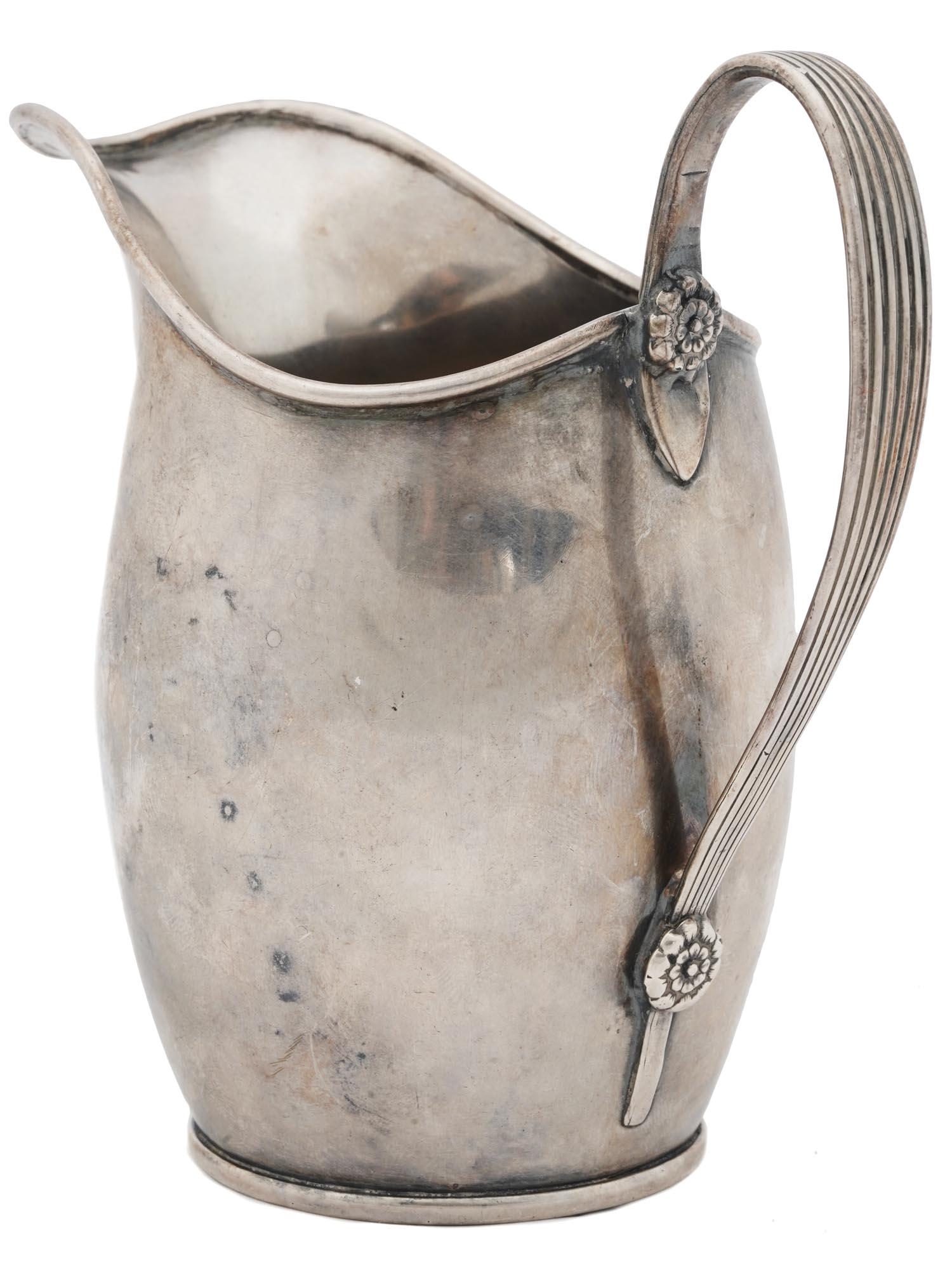 STERLING SILVER PITCHER CREAMER WITH HANDLE: A classic sterling silver creamer of a rounded shape. The handle is decorated with ornamental metalwork. Weight: 100 grams. Collectible Silverware Tableware Serveware. Dimensions: 4 1/2 in Tall. All m